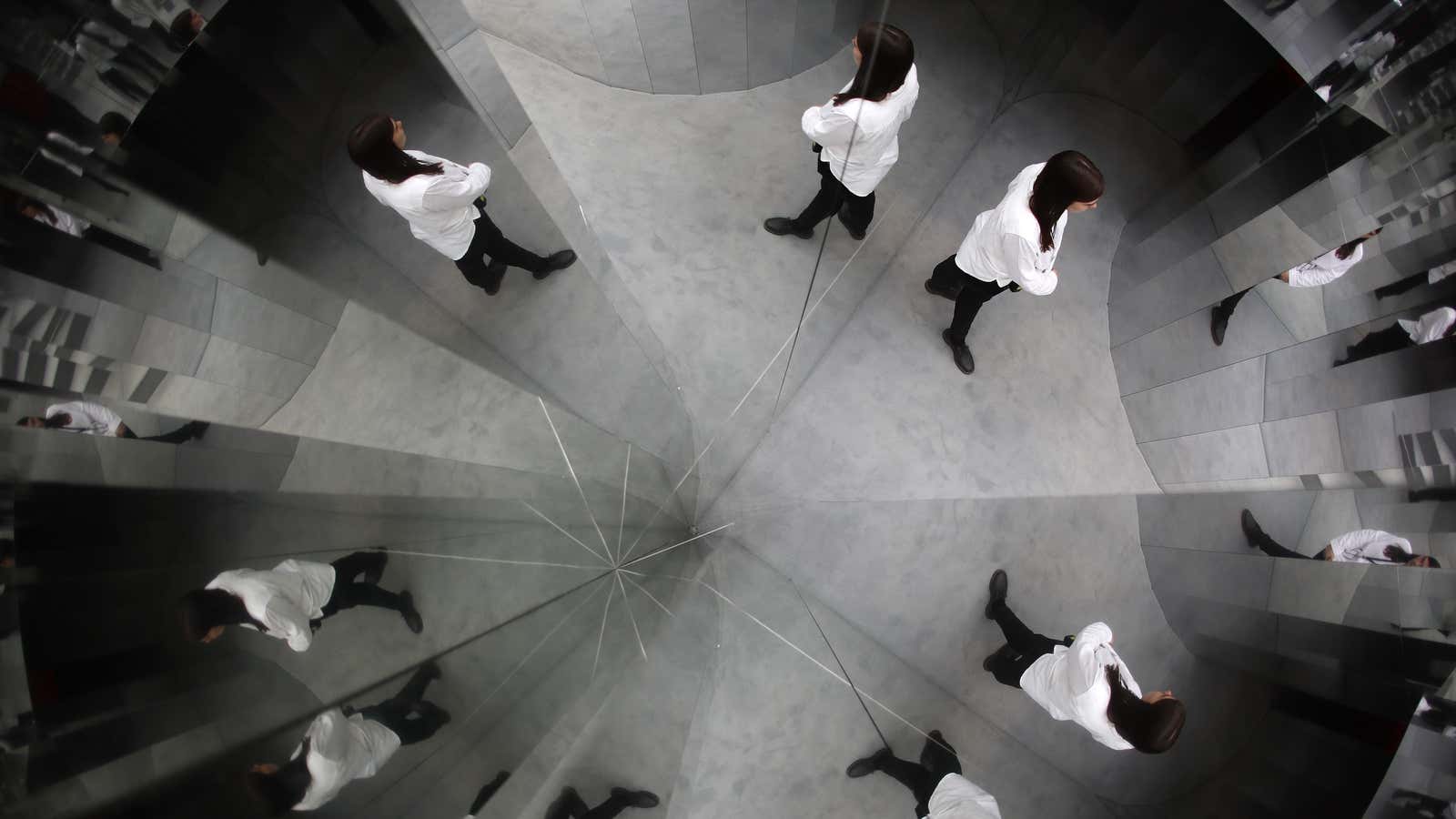 A guide is reflected in the installation Mirror Maze by artist Es Devlin, at the Copeland Park in Peckham, south London, Britain September 21, 2016.