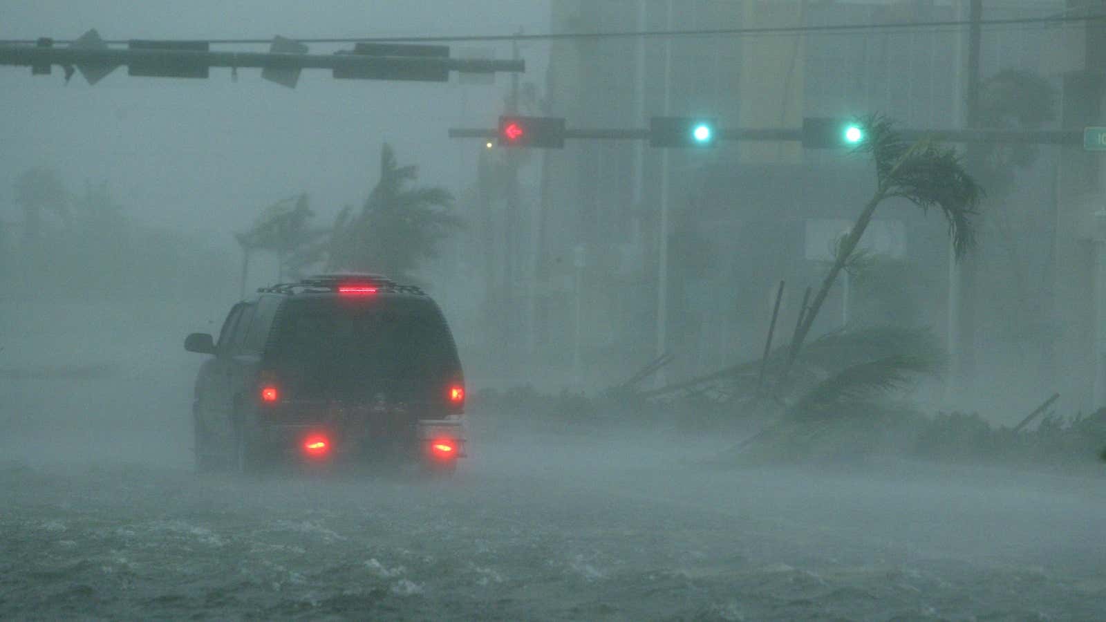 An SUV passes through flooding in downtown Naples, Florida, as Hurricane Wilma passes over the city in Oct. 2005.