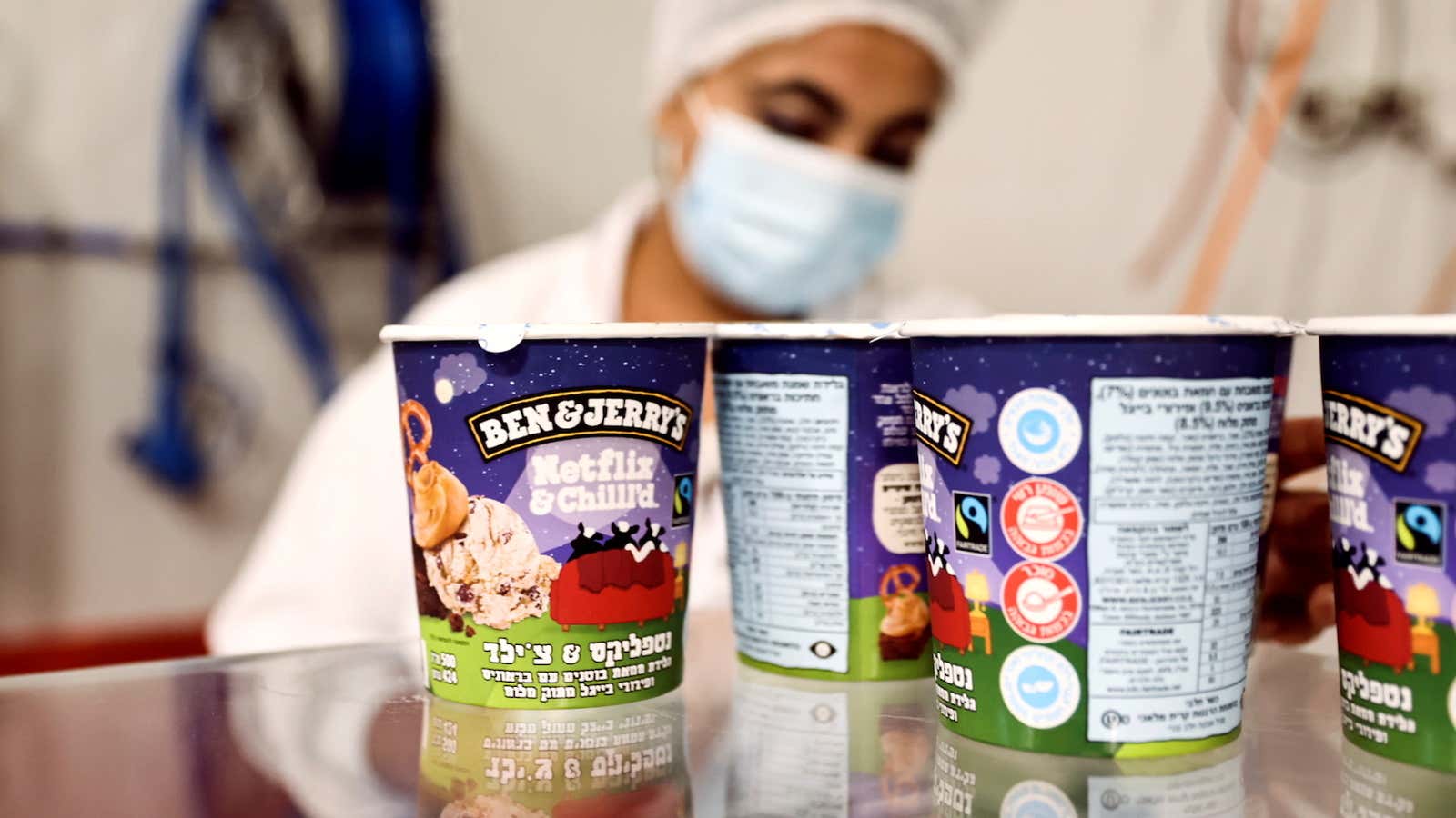 Tubs of ice-cream are seen as a labourer works at Ben &amp; Jerry’s factory in Be’er Tuvia, Israel July 20, 2021.