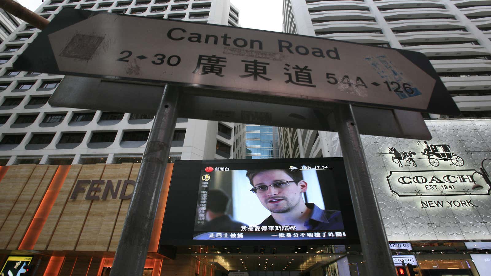 Snowden’s image is broadcast over a Hong Kong street.