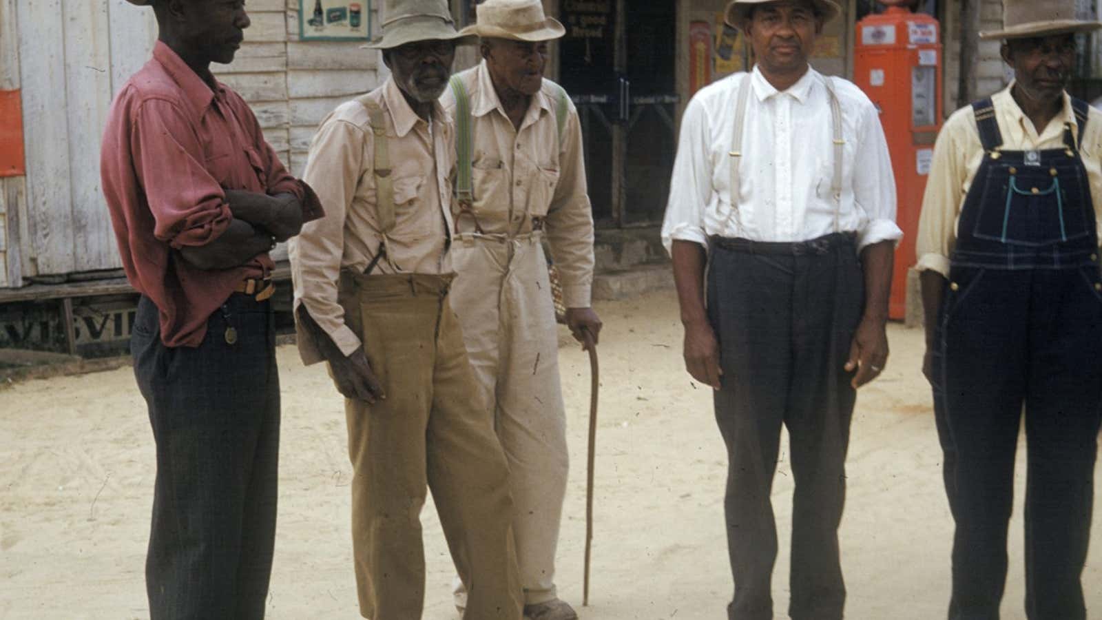 In this 1950’s photo released by the National Archives, men included in a syphilis study pose for a photo in Tuskegee, Ala.