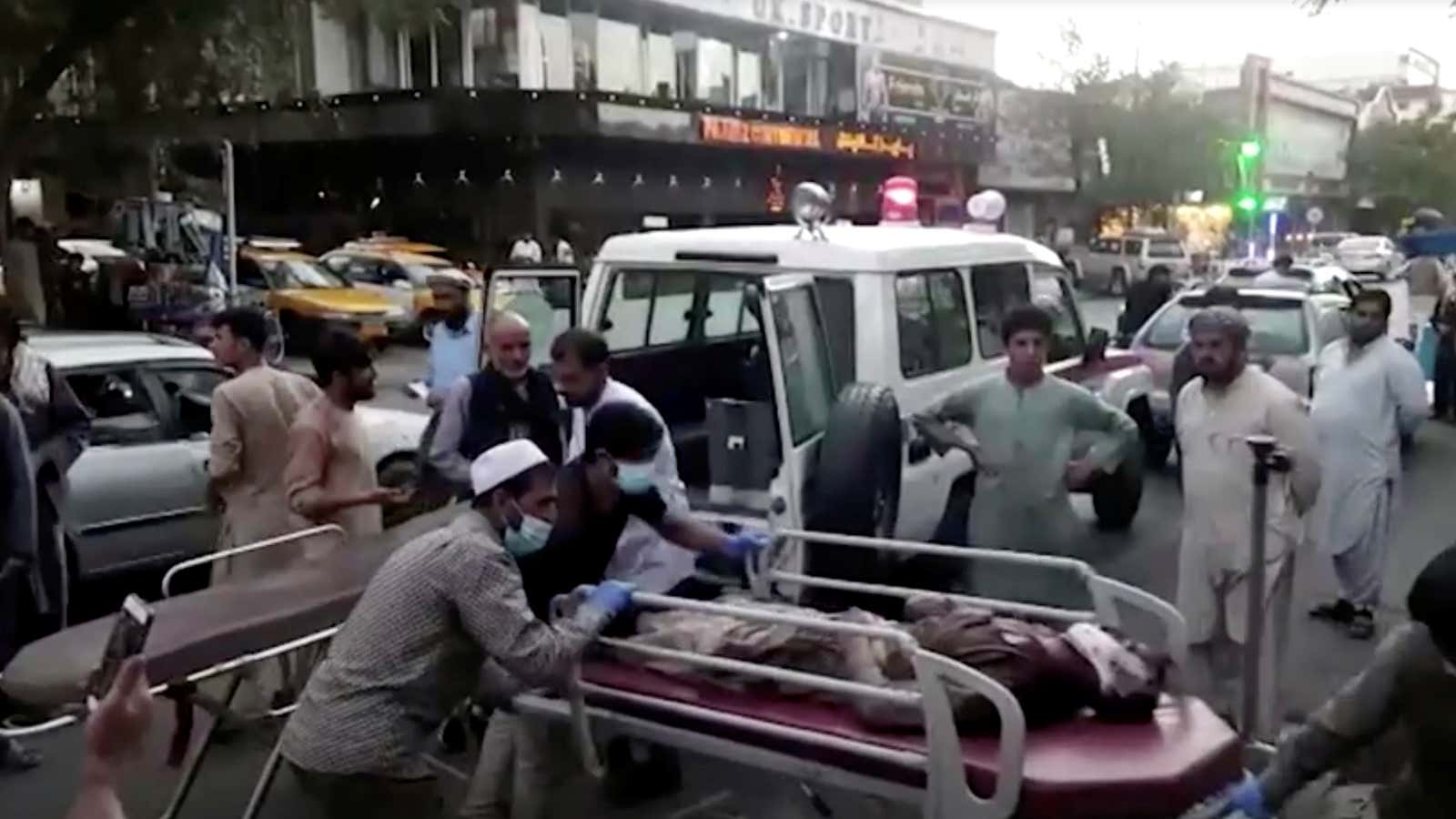 A screen grab shows people carrying an injured person to a hospital after an attack at Kabul airport, in Kabul, Afghanistan August 26, 2021. REUTERS TV/1TV/Handout via REUTERS    THIS IMAGE HAS BEEN SUPPLIED BY A THIRD PARTY. MANDATORY CREDIT. NO RESALES. NO ARCHIVES. AFGHANISTAN OUT. NO COMMERCIAL OR EDITORIAL SALES IN AFGHANISTAN