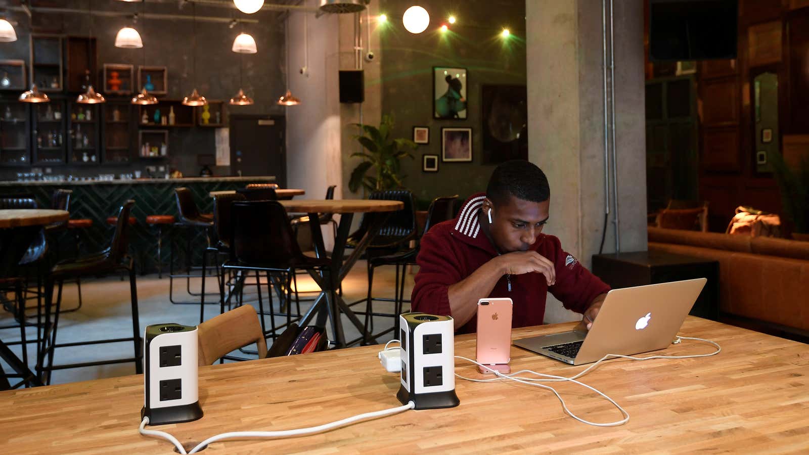 A resident or ‘member’ works at a computer in a shared space at The Collective co-living building in west London, August 14, 2017. Picture taken…