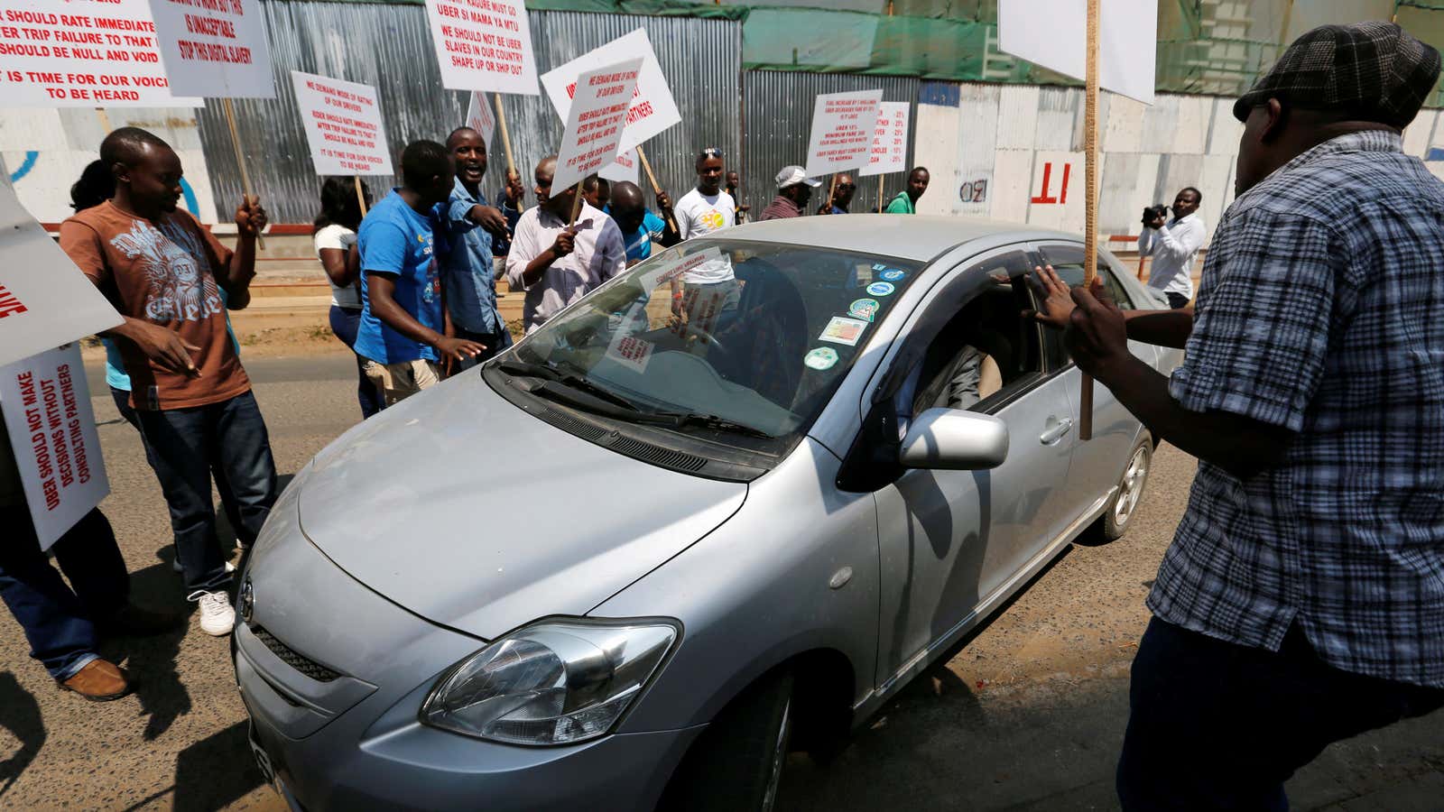 Kenyan taxi drivers attempt to eject an Uber passenger in Nairobi as tensions ran high last year