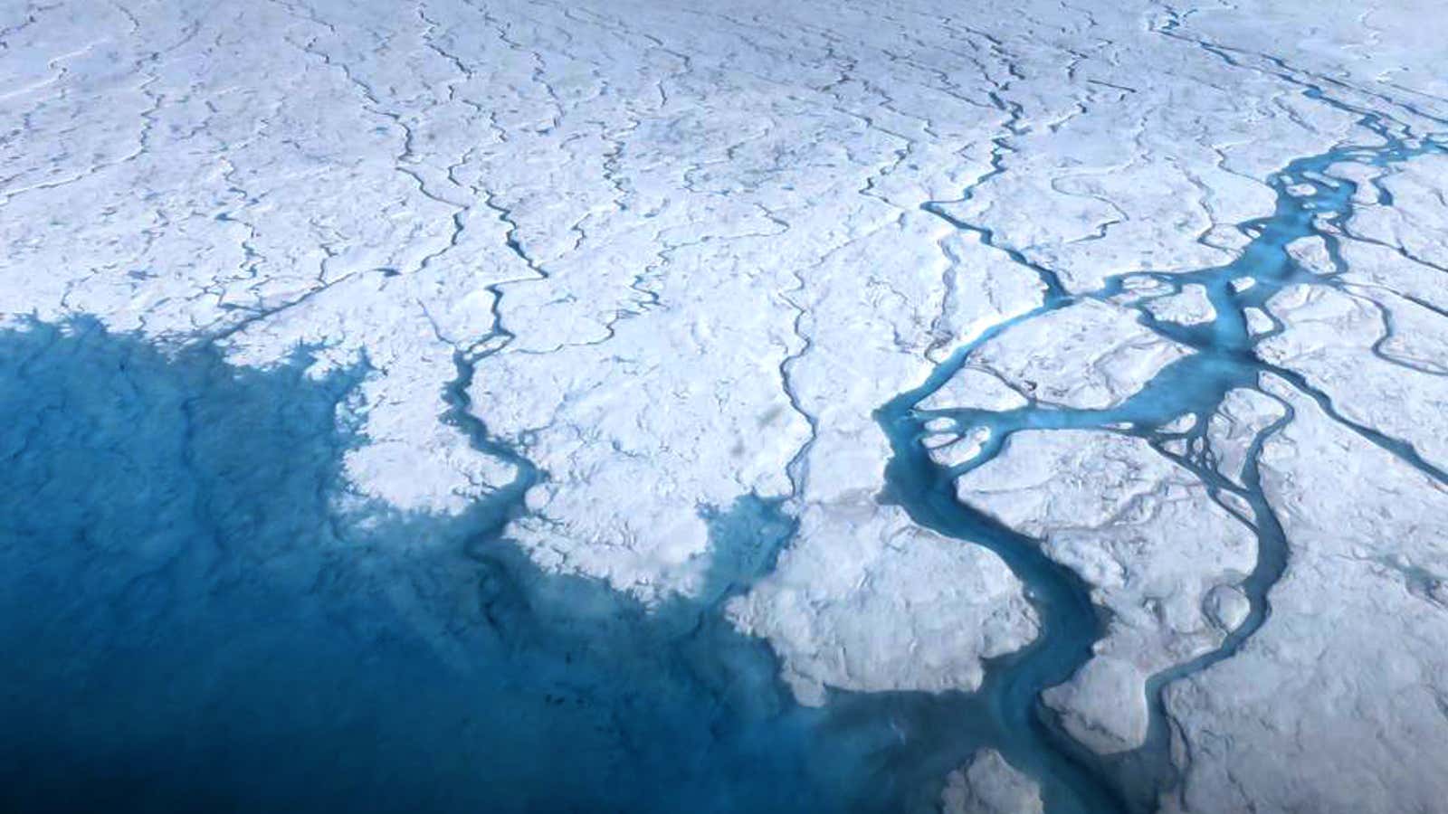 Streams of flowing meltwater on top of an ice sheet, 2015.