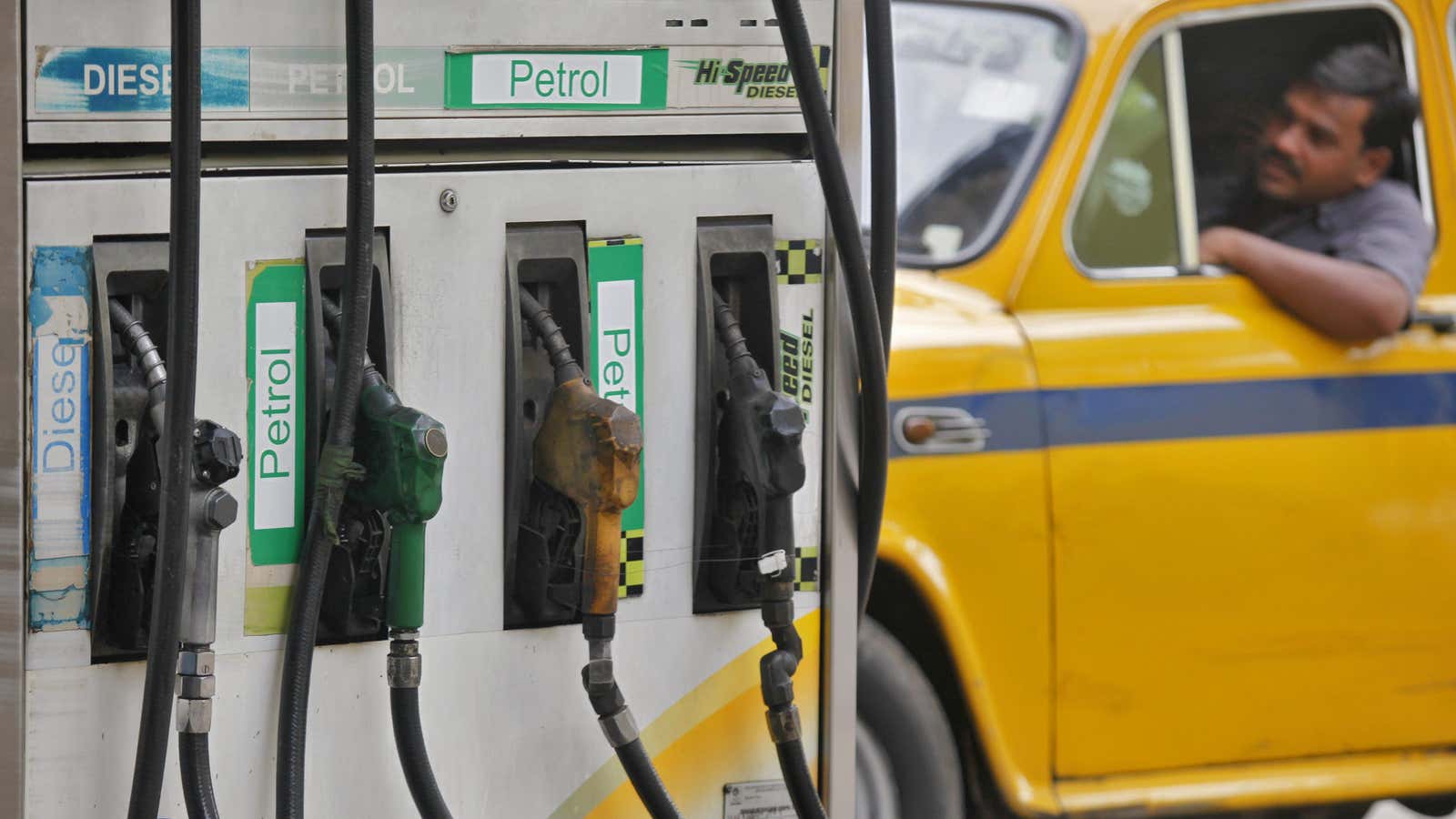 A driver waits in a taxi for his turn to fill up his tank with diesel at a fuel station in Kolkata June 14, 2012.…