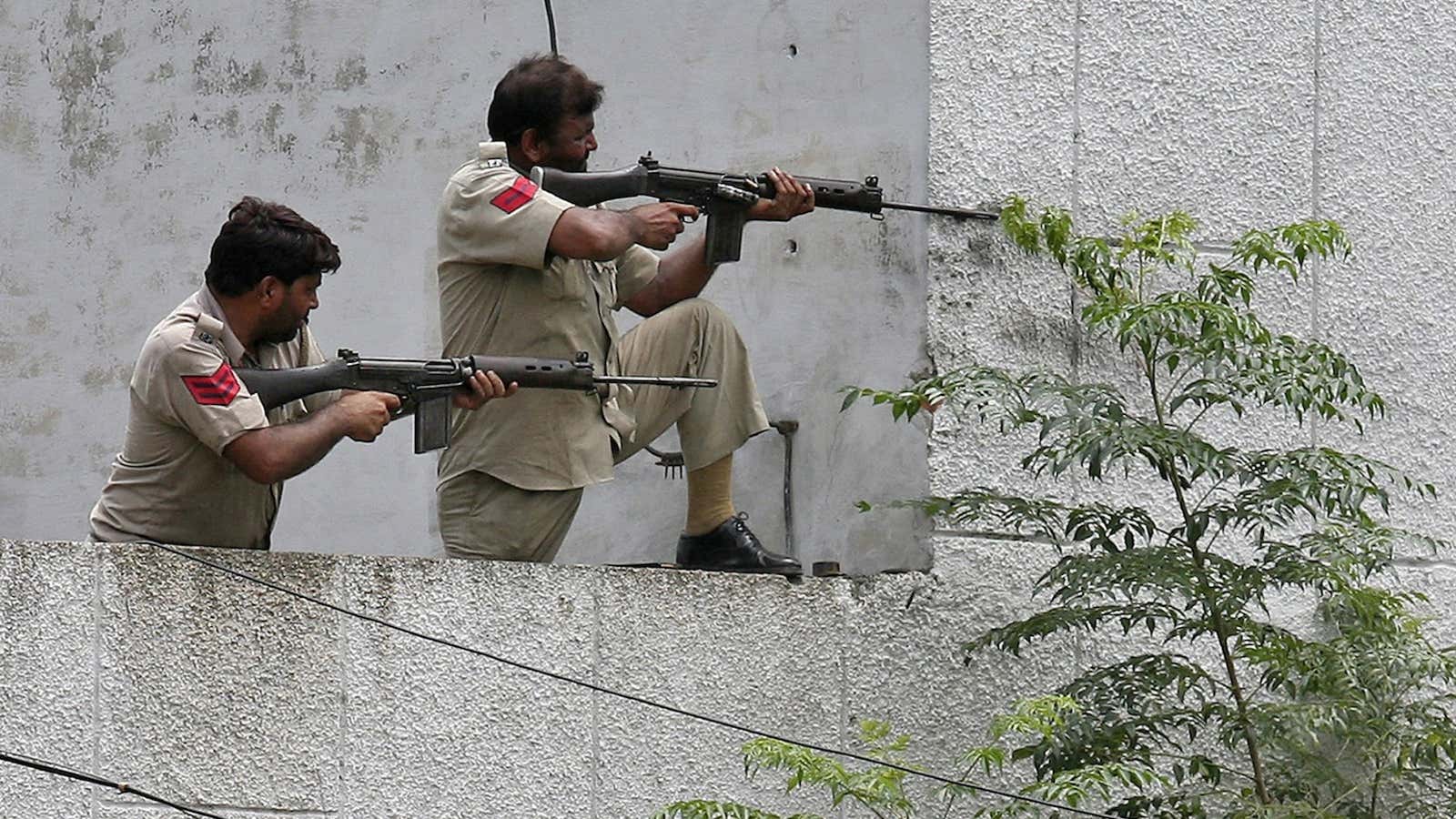 Policemen take their positions during the gunfight.