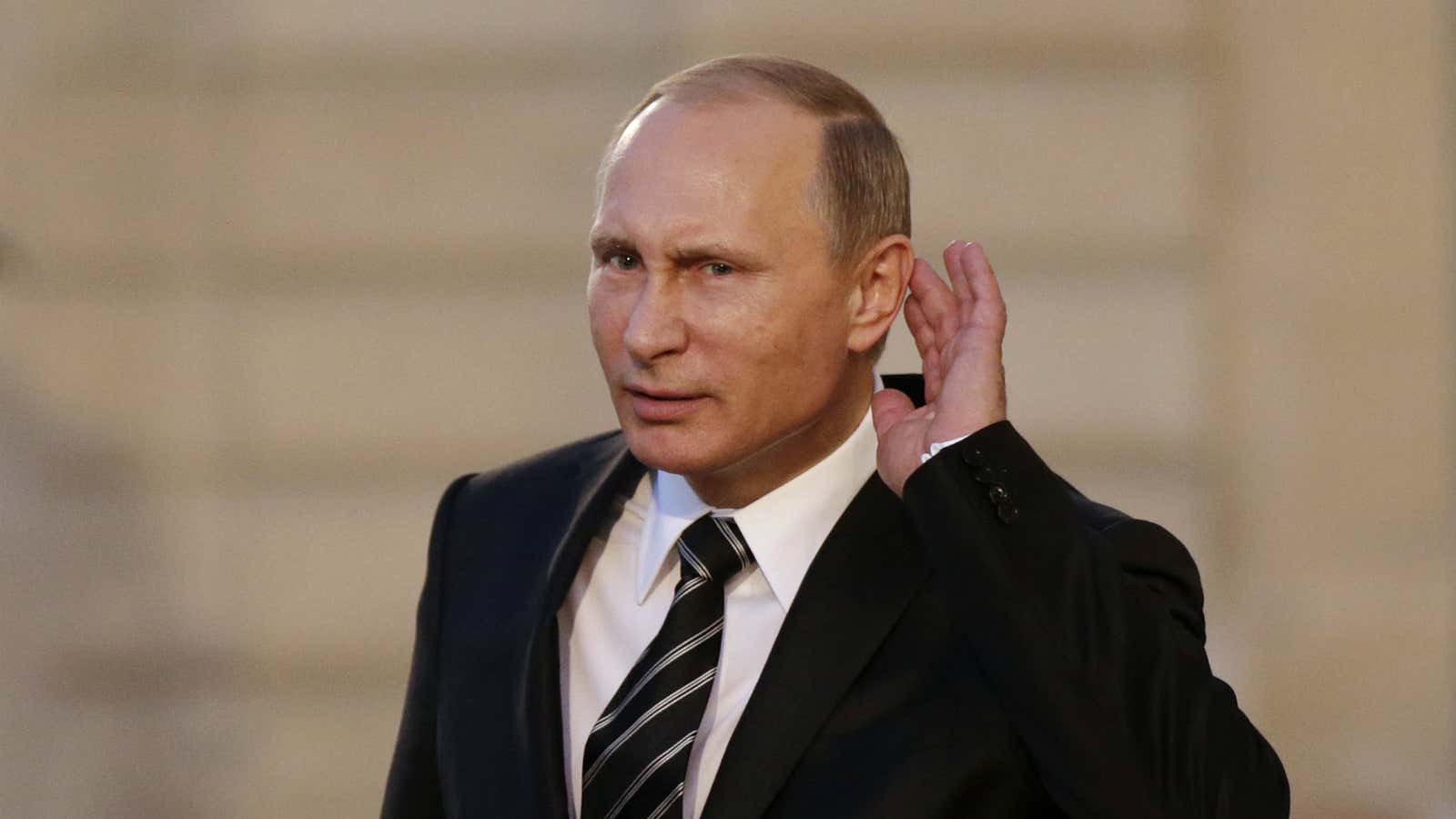 Russian President Vladimir Putin cups his ear to listen to a question in Paris, France, Oct 2, 2015.