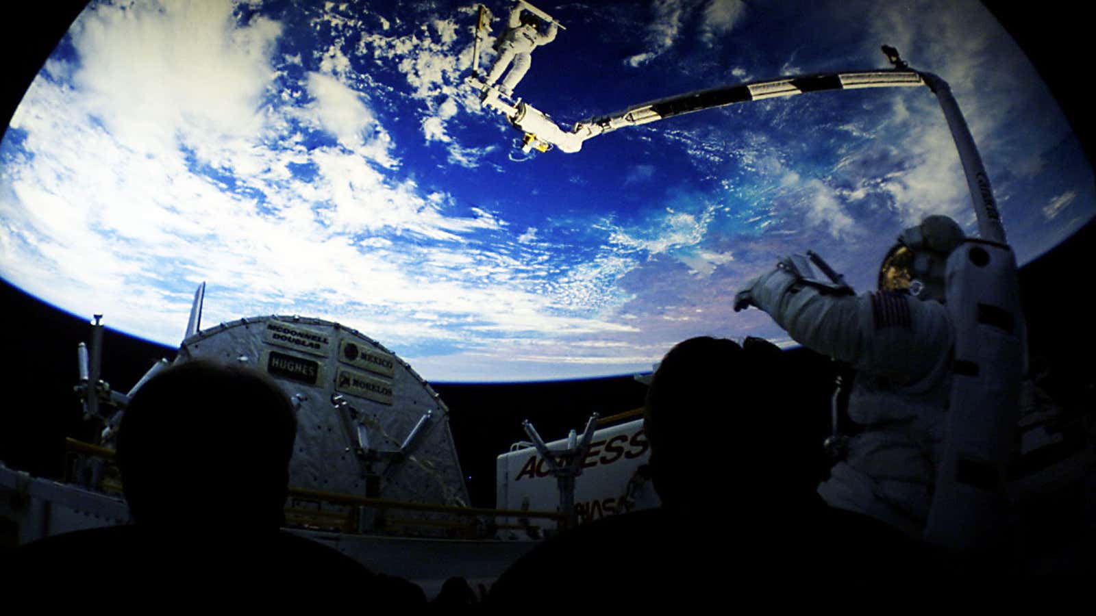 Cinema goers watch a preview for a movie about space exploration at the new IMAX theatre in Glasgow  October 10, 2000. The new 370 seat theatre has the biggest cinema screen in Scotland at 24×18 metres, which is bigger than a five storey tenement block.