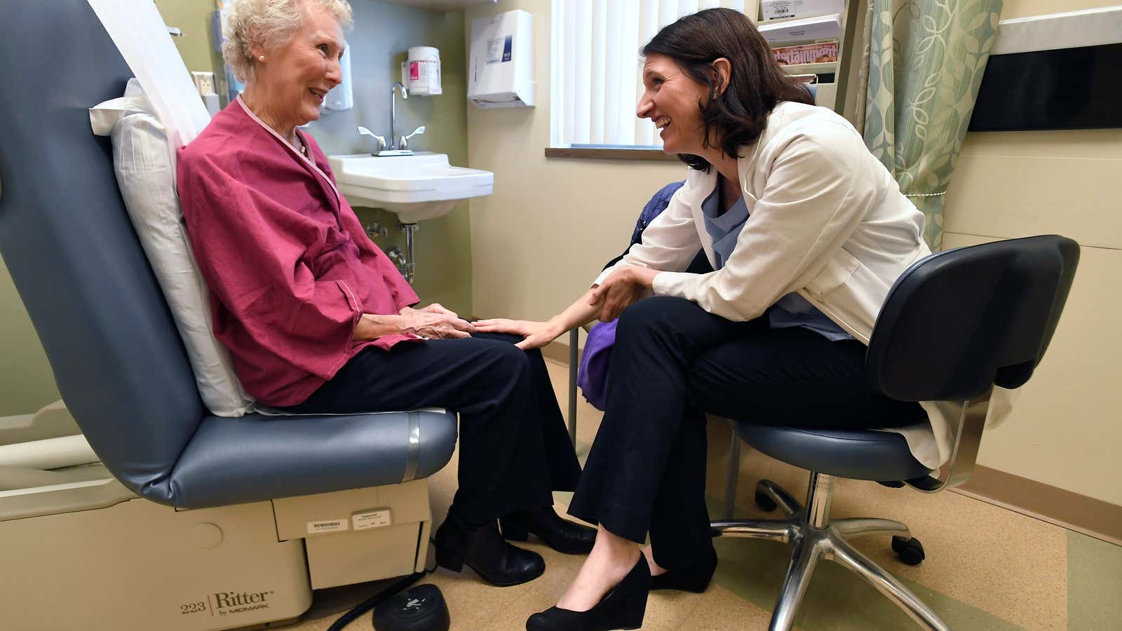 In this Monday, March 4, 2019 photo, Dr. Allison Magnuson, left, speaks with patient Nancy Simpson at the Pluta Cancer Center in Rochester, N.Y. Before…