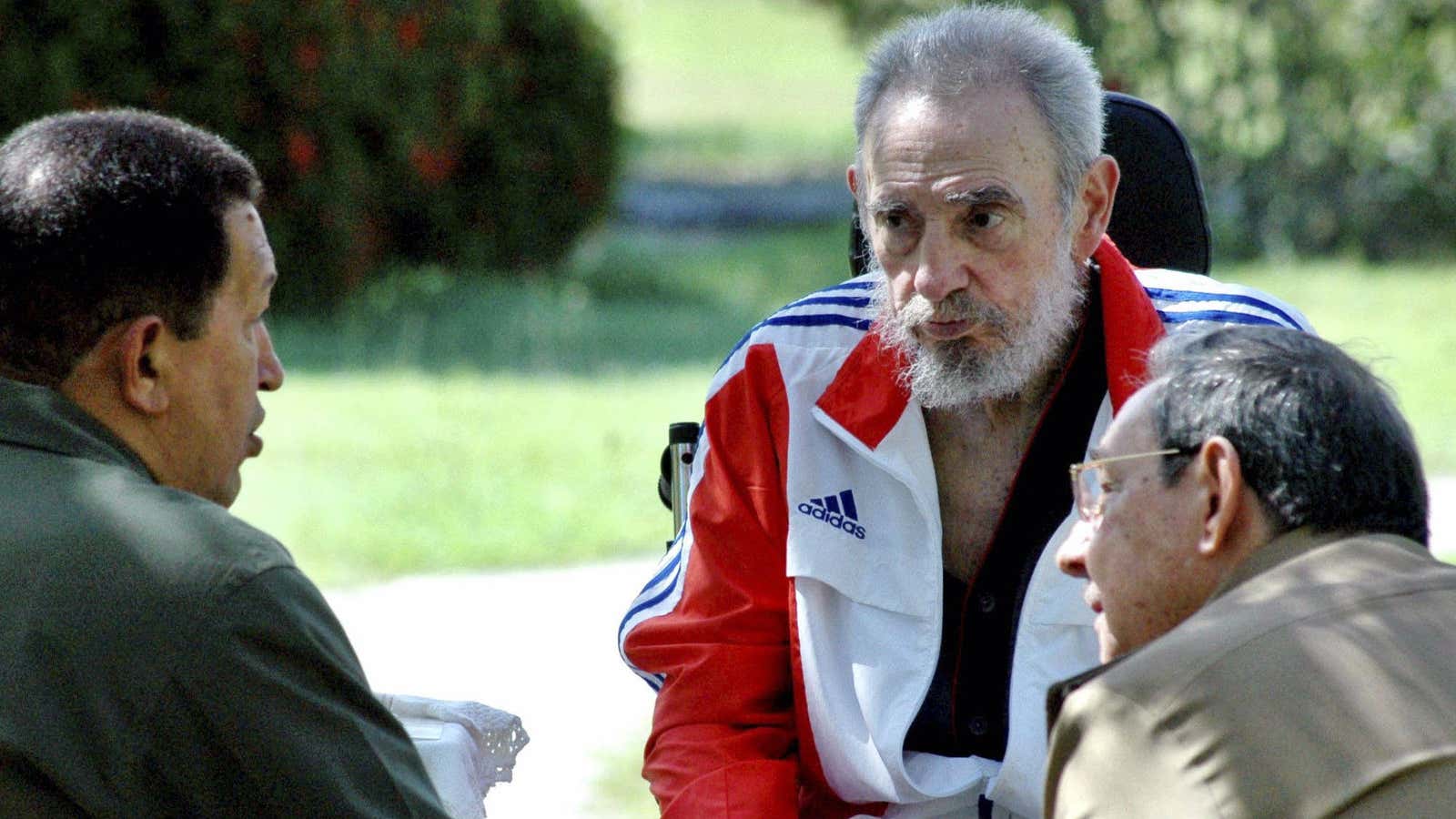 Fidel (center) and Raul Castro (right) with the late Hugo Chavez