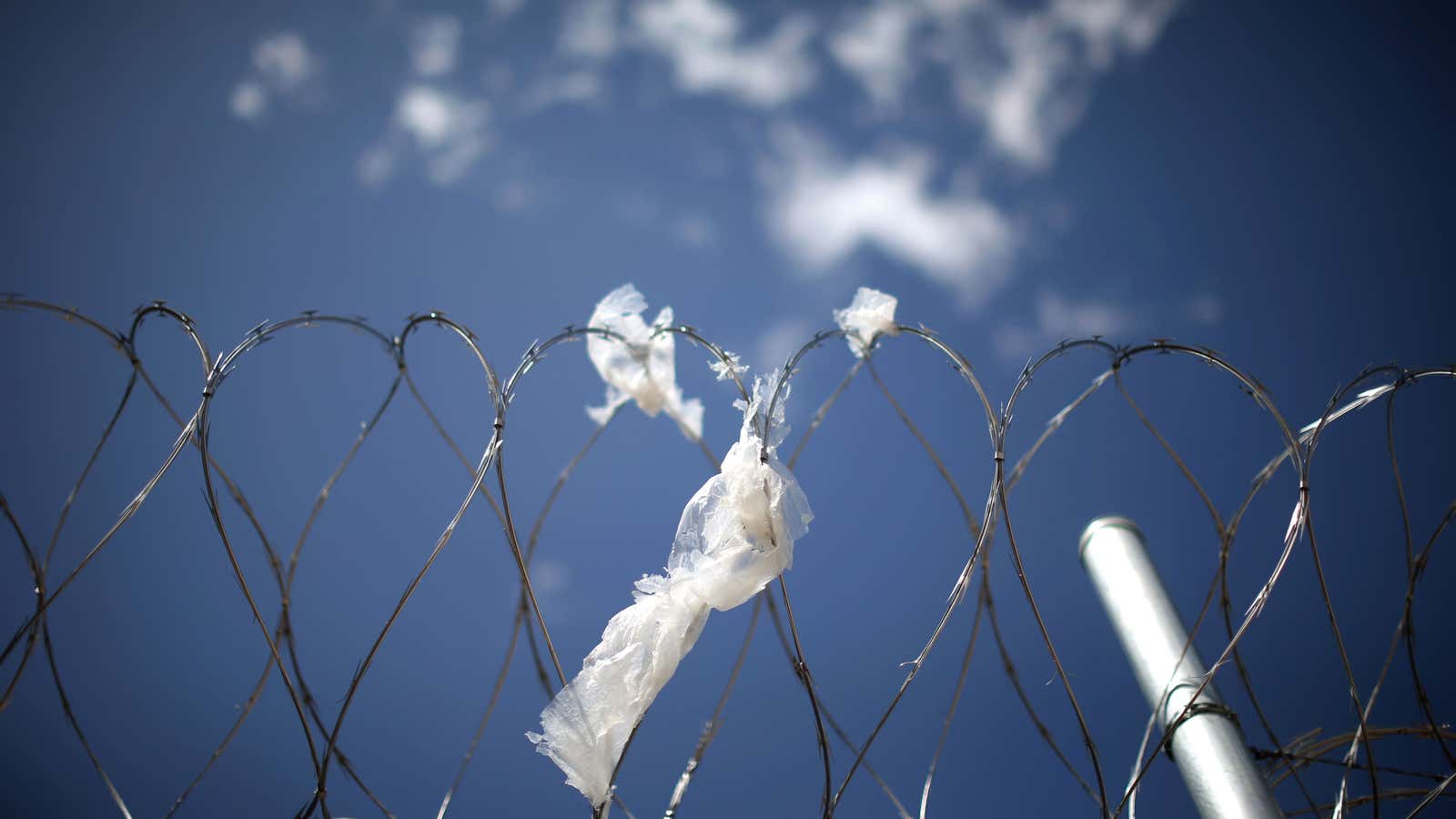 Razor wire surrounds the Adelanto immigration detention center, an ICE facility run by the GEO Group in Adelanto, California.