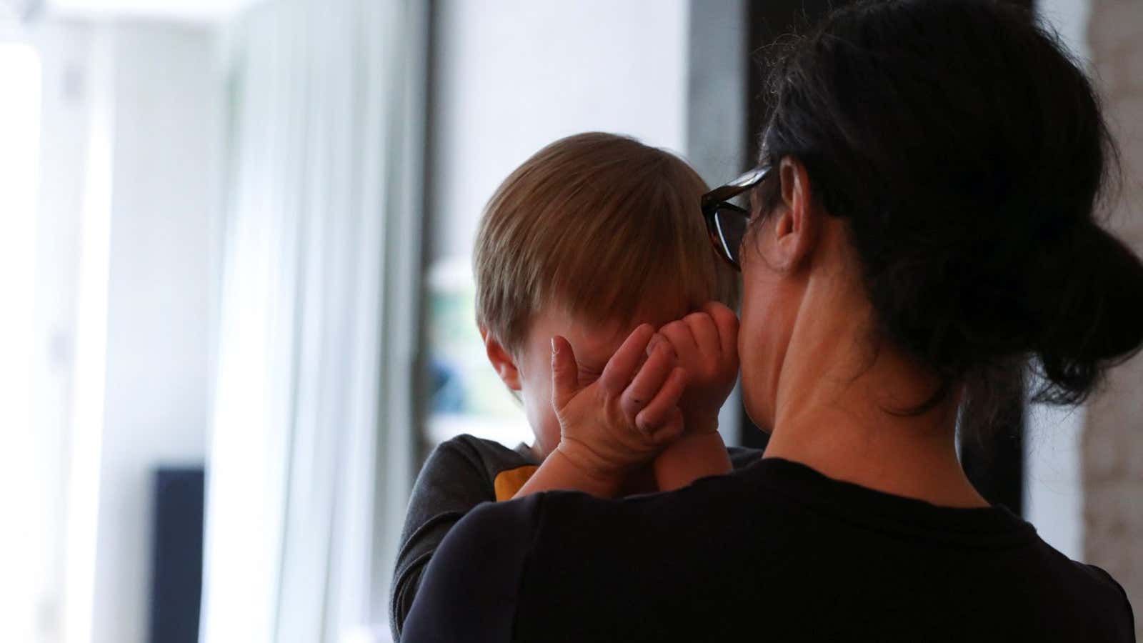 A young boy is comforted by his mother