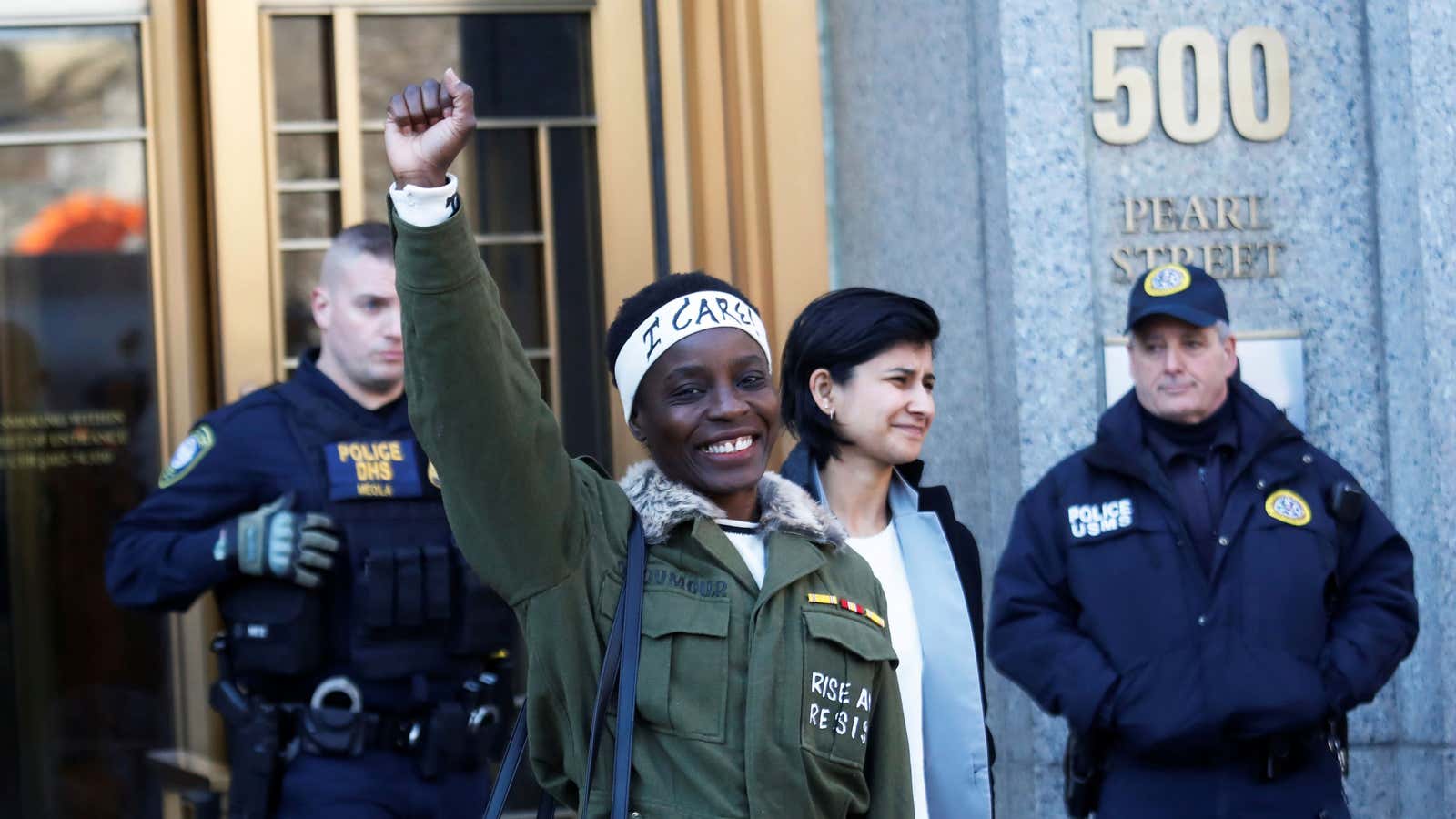 Therese Patricia Okoumou raises her fist after her sentencing outside a federal court in New York, Mar. 19, 2019.