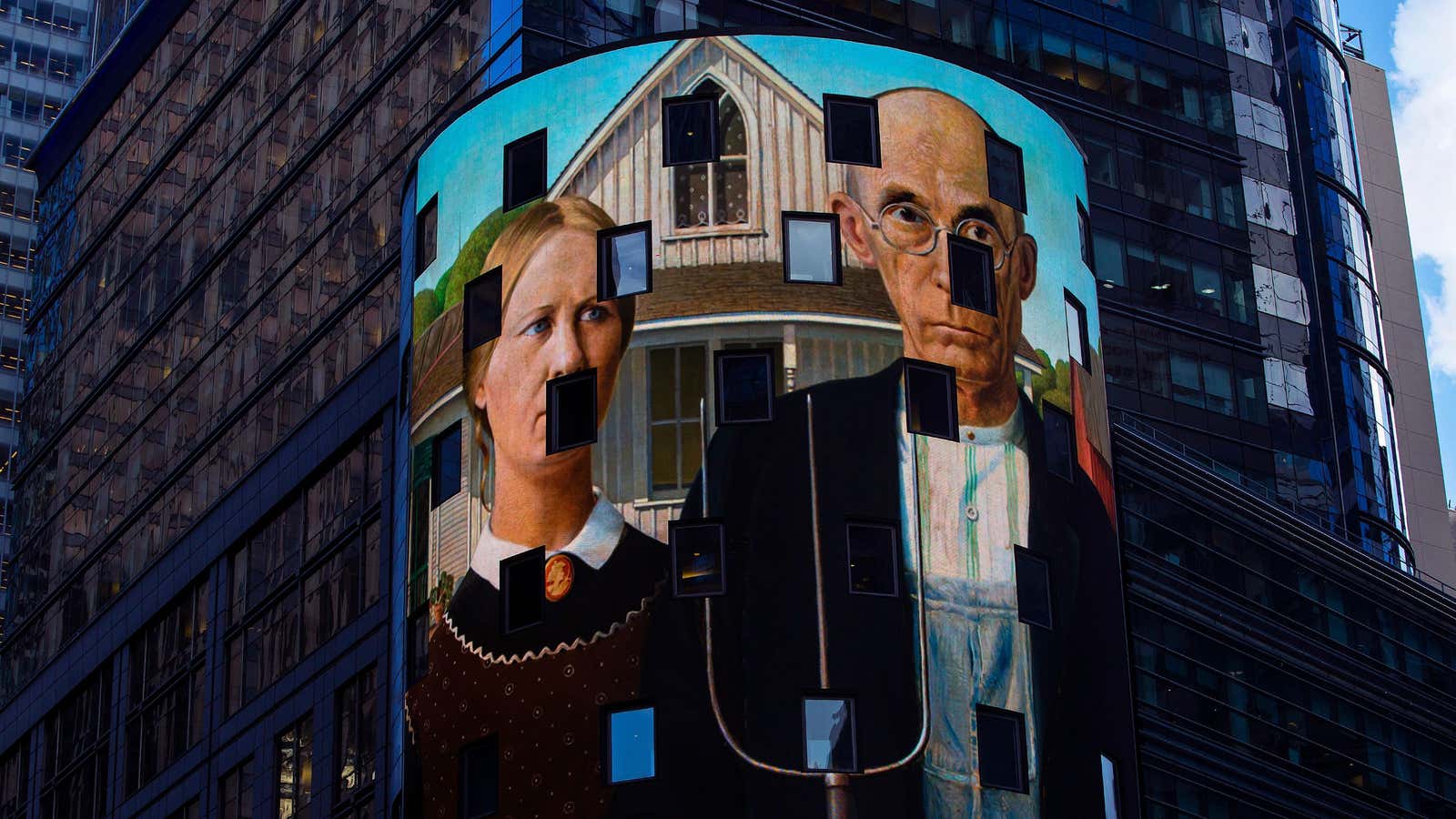 A reproduction of the art work “American Gothic” is displayed on a digital billboard in Times Square,