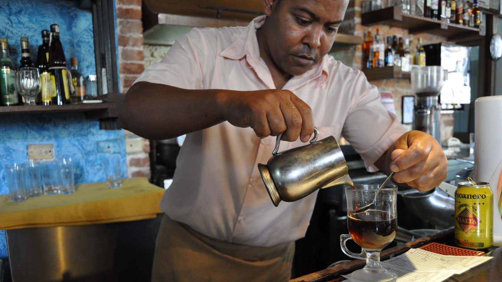 Longtime Cuban barista Miguel Angel Ponce at El Escorial slowly pours espresso to make the perfect Irish coffee.