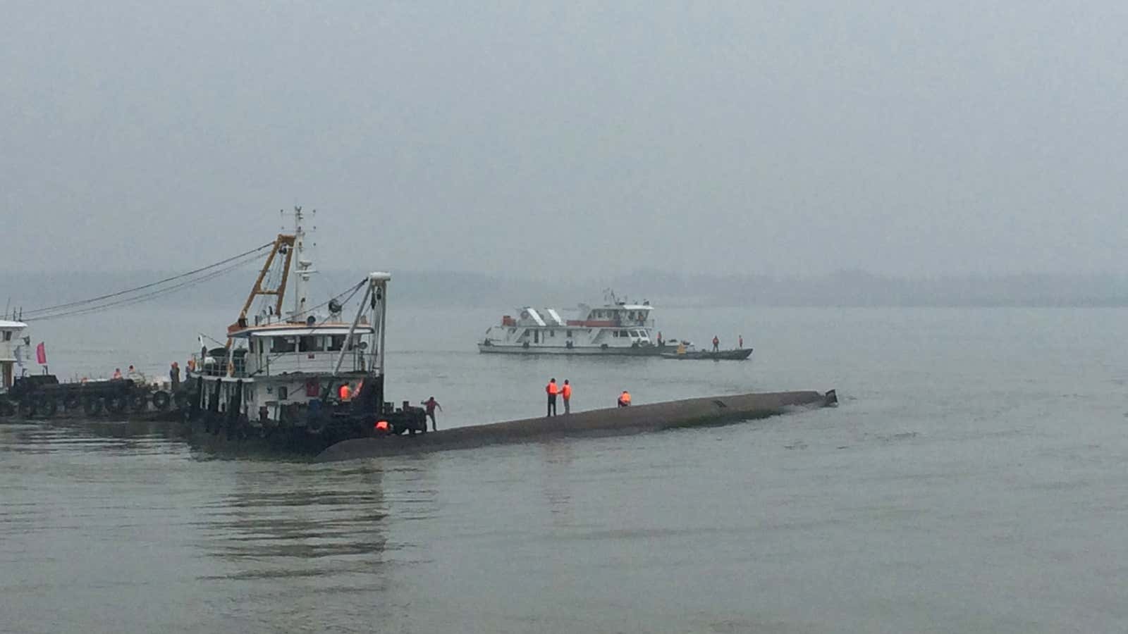 Rescue workers search on a sunken ship that was carrying 458 people on China’s Yangtze River in Hubei province.