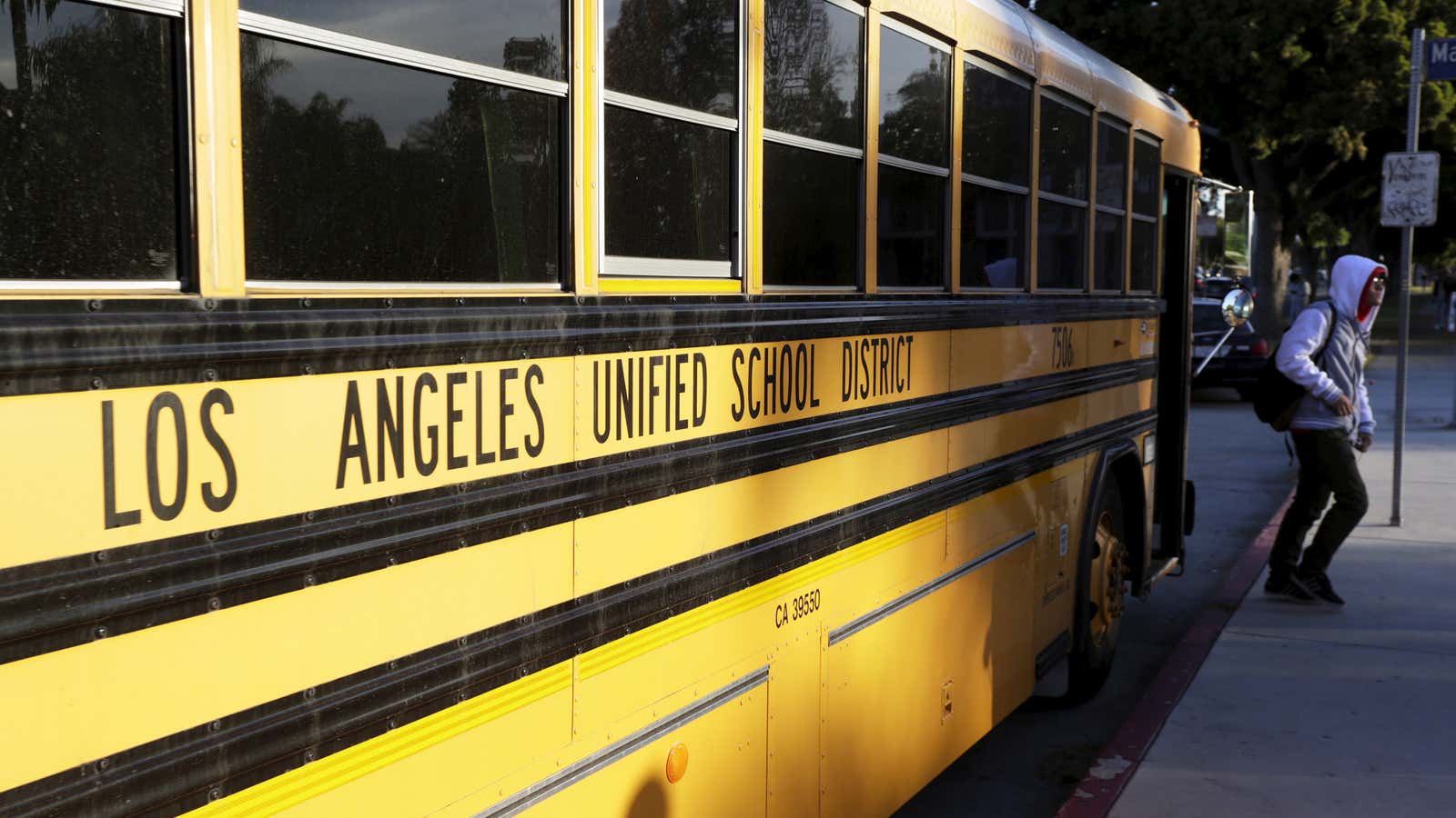 A student exits a bus as he arrives at Venice High School in Los Angeles, California December 16, 2015. Classes resume today in Los Angeles,…