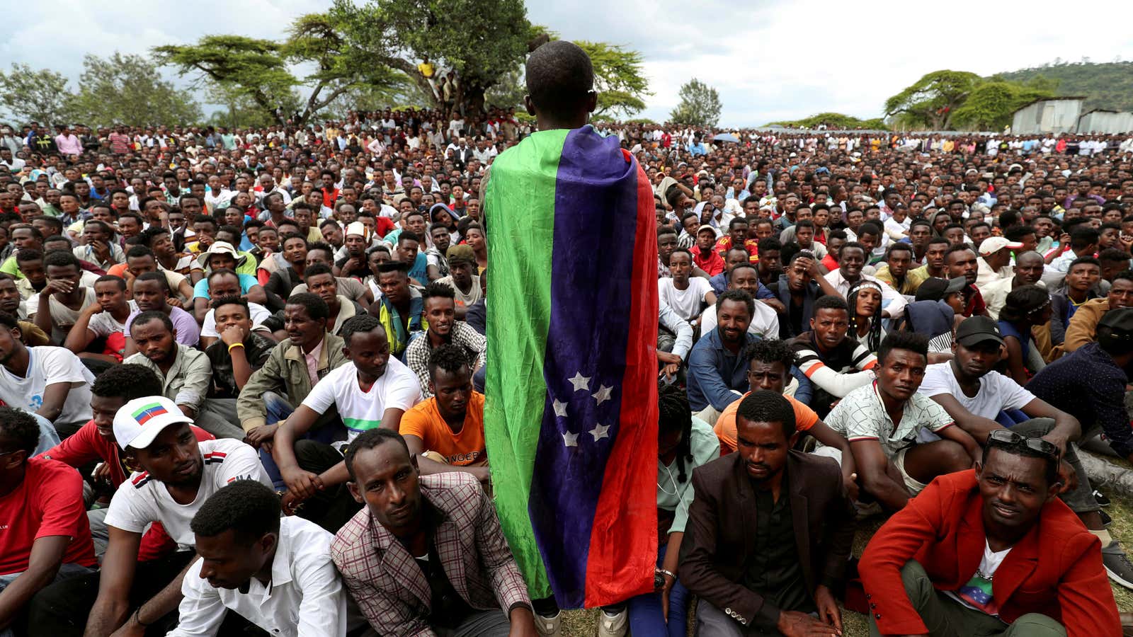 A Sidama youth leader carrying a flag addresses people as they gather for a meeting to declare their own region in Hawassa, Ethiopia July, 17, 2019.