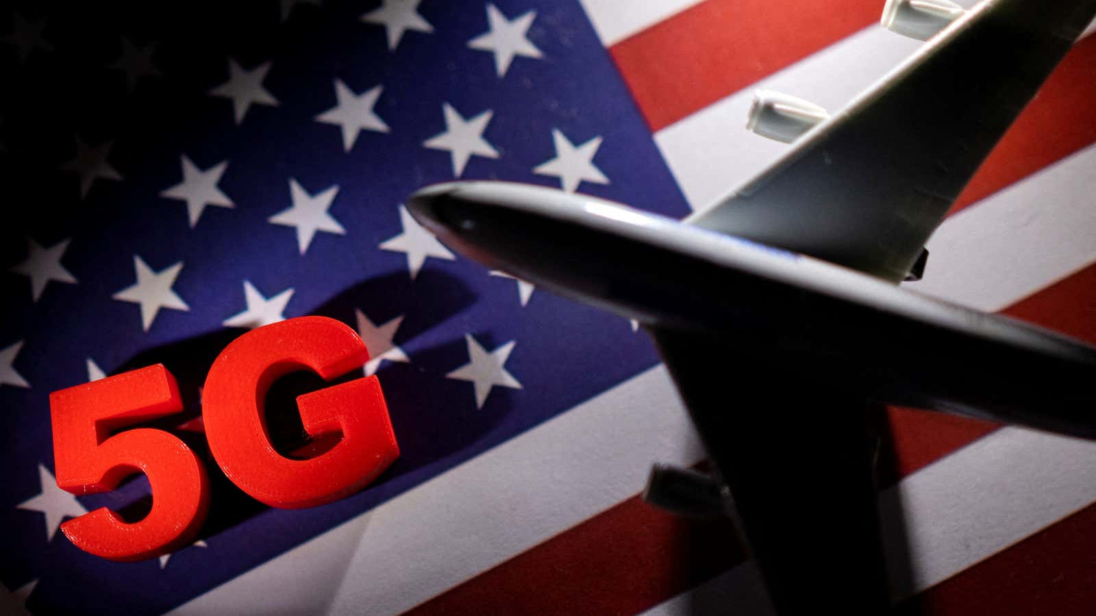 An illustration of an airplane soaring in front of an American flag with “5G” emblazoned on it.