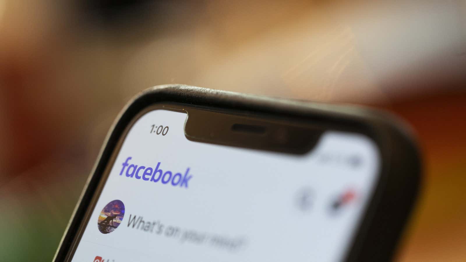 FILE – In this Aug. 11, 2019, file photo an iPhone displays a Facebook page in New Orleans. Social media platforms are facing intense, often…