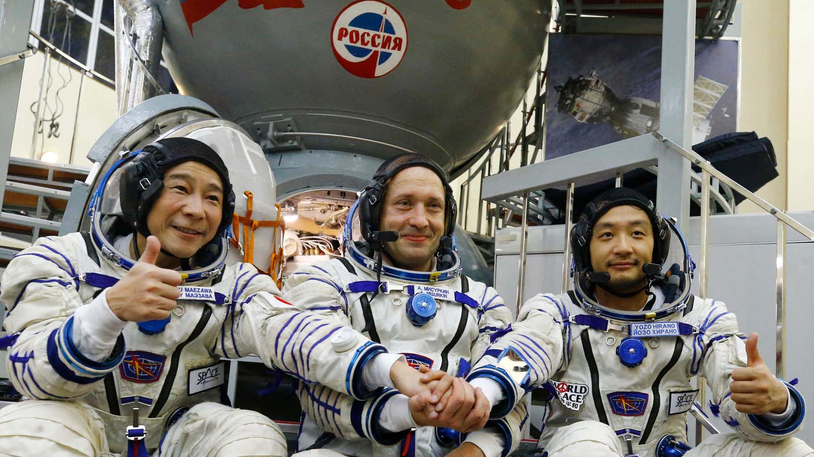 Russian cosmonaut Alexander Misurkin (C) and space flight participants - Japanese billionaire Yusaku Maezawa (L) and his assistant Yozo Hirano - attend a training ahead of the expedition to the International Space Station, in Star City outside Moscow on October 14, 2021. 