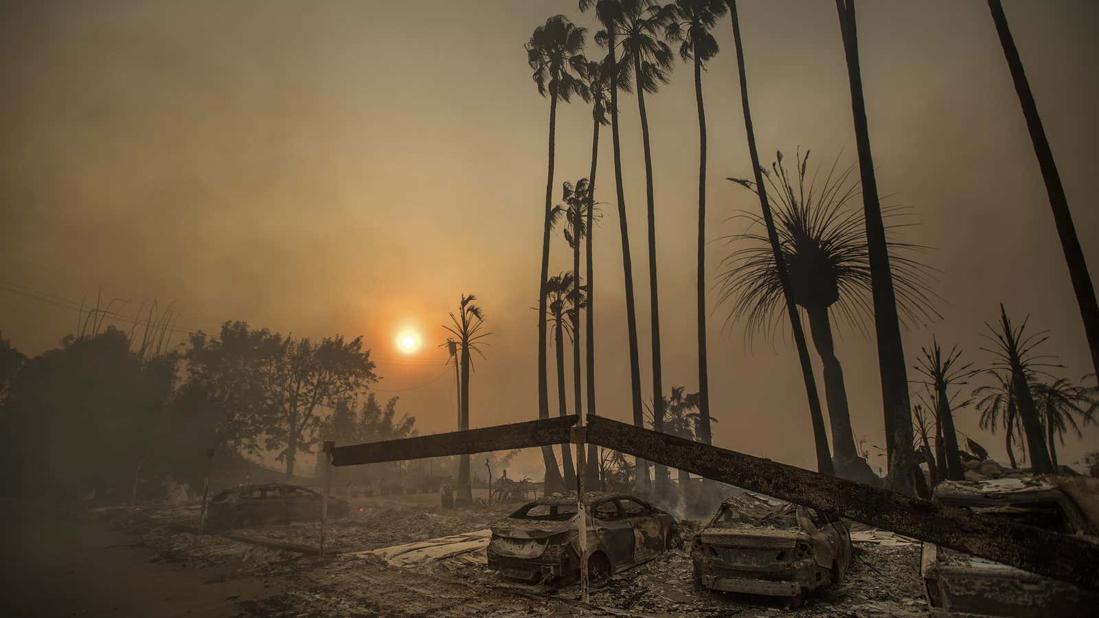 Smoke rises behind a leveled apartment complex in Ventura.