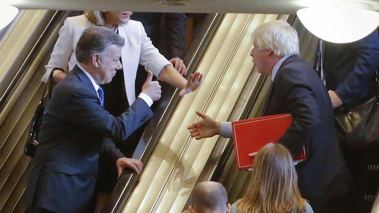 Columbia’s President Juan Manuel Santos, left, shows a thumbs up as British Foreign Secretary Boris Johnson, right, reaches for a handshake, as the past each…