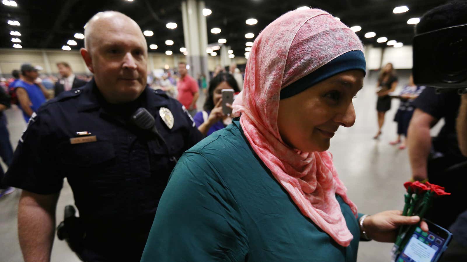 Police escort a Muslim woman from a Trump rally in North Carolina.