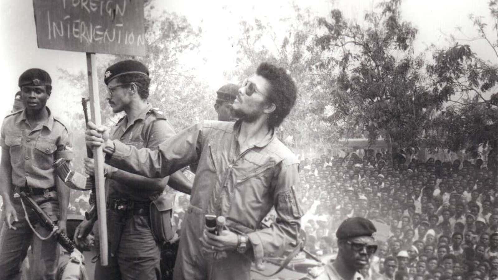 Rawlings reading a placard at a 1981 demonstration in Nicholson Stadium, Accra.