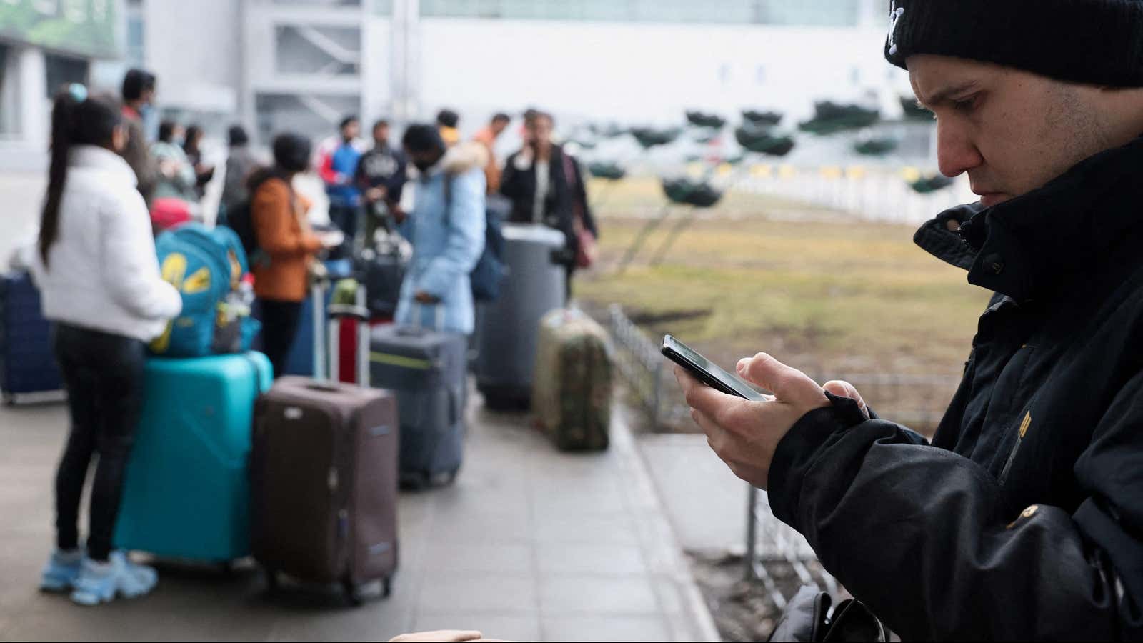 People wait at a Kyiv airport after Russia authorized a military operation in Ukraine.