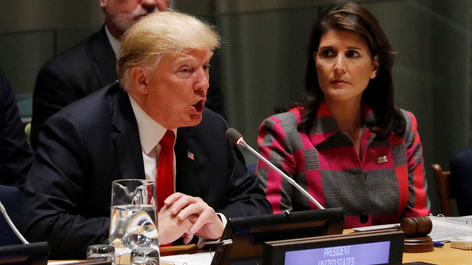 Trump speaks as UN ambassador Nikki Haley looks on.