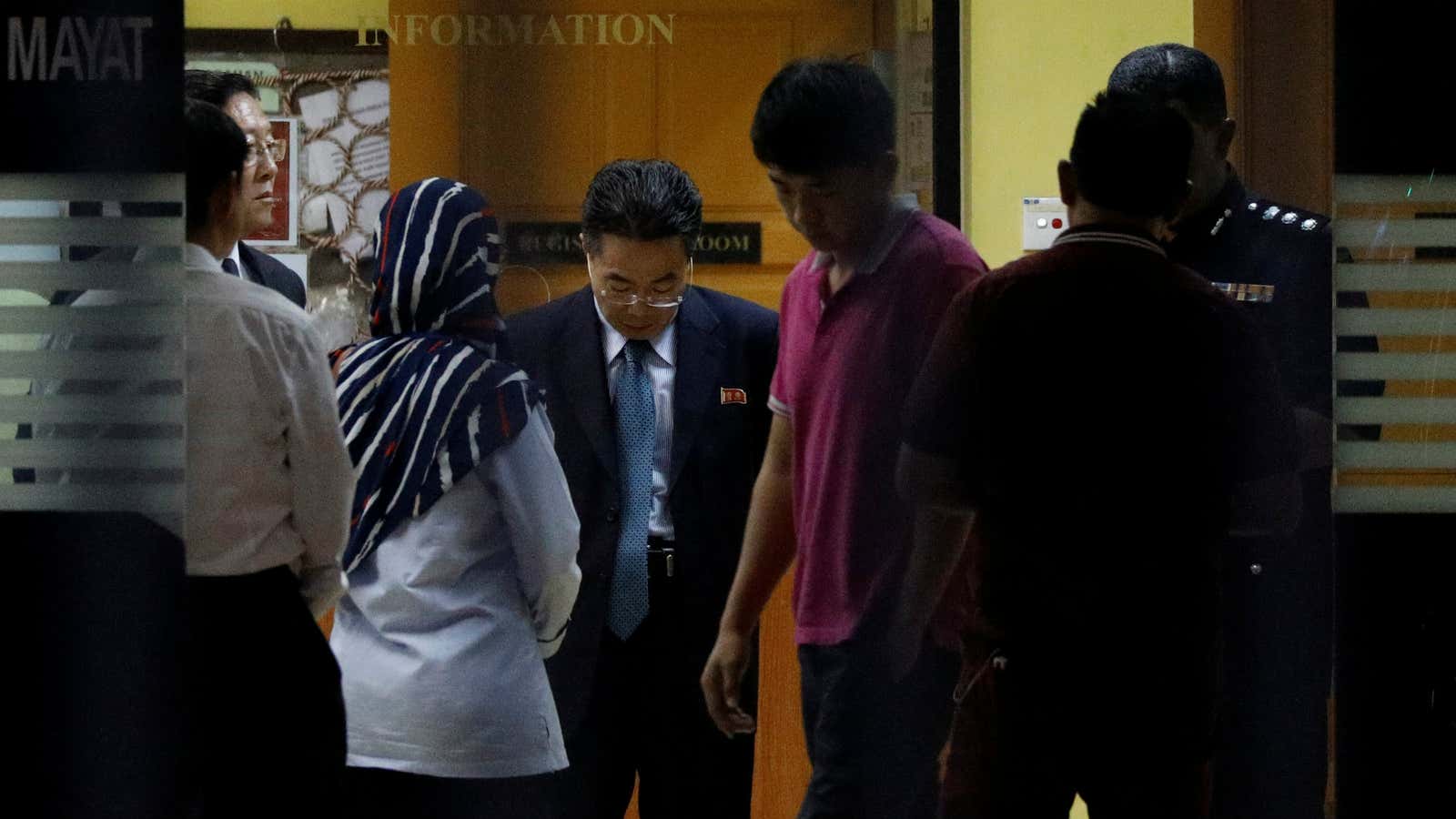 A North Korea official speaks with officials at the morgue in Kuala Lumpur where Kim Jong-nam’s body is being held.