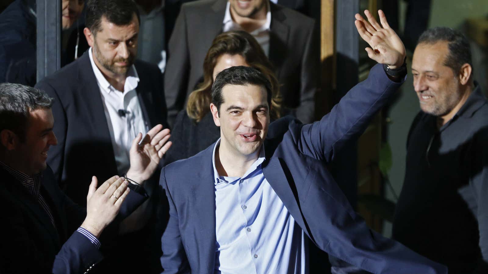 Head of radical leftist Syriza party Alexis Tsipras waves while leaving the party headquarters after winning the elections in Athens, January 25, 2015. Greek leftist…