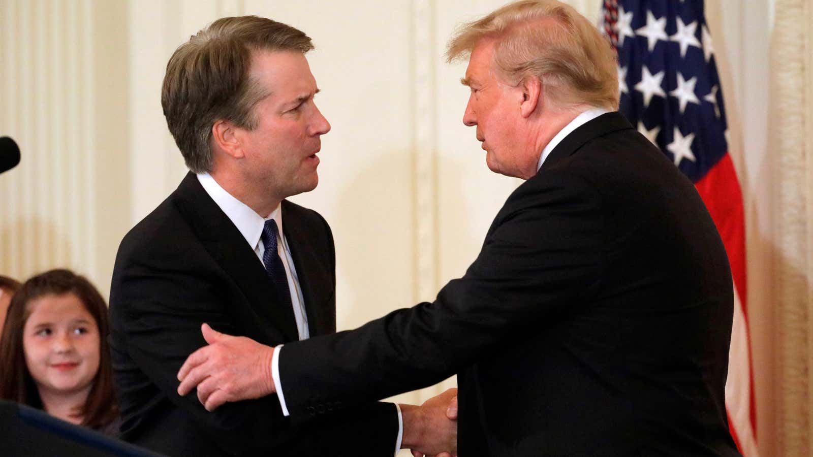 Supreme Court nominee Brett Kavanaugh shakes hands with US president Donald Trump.