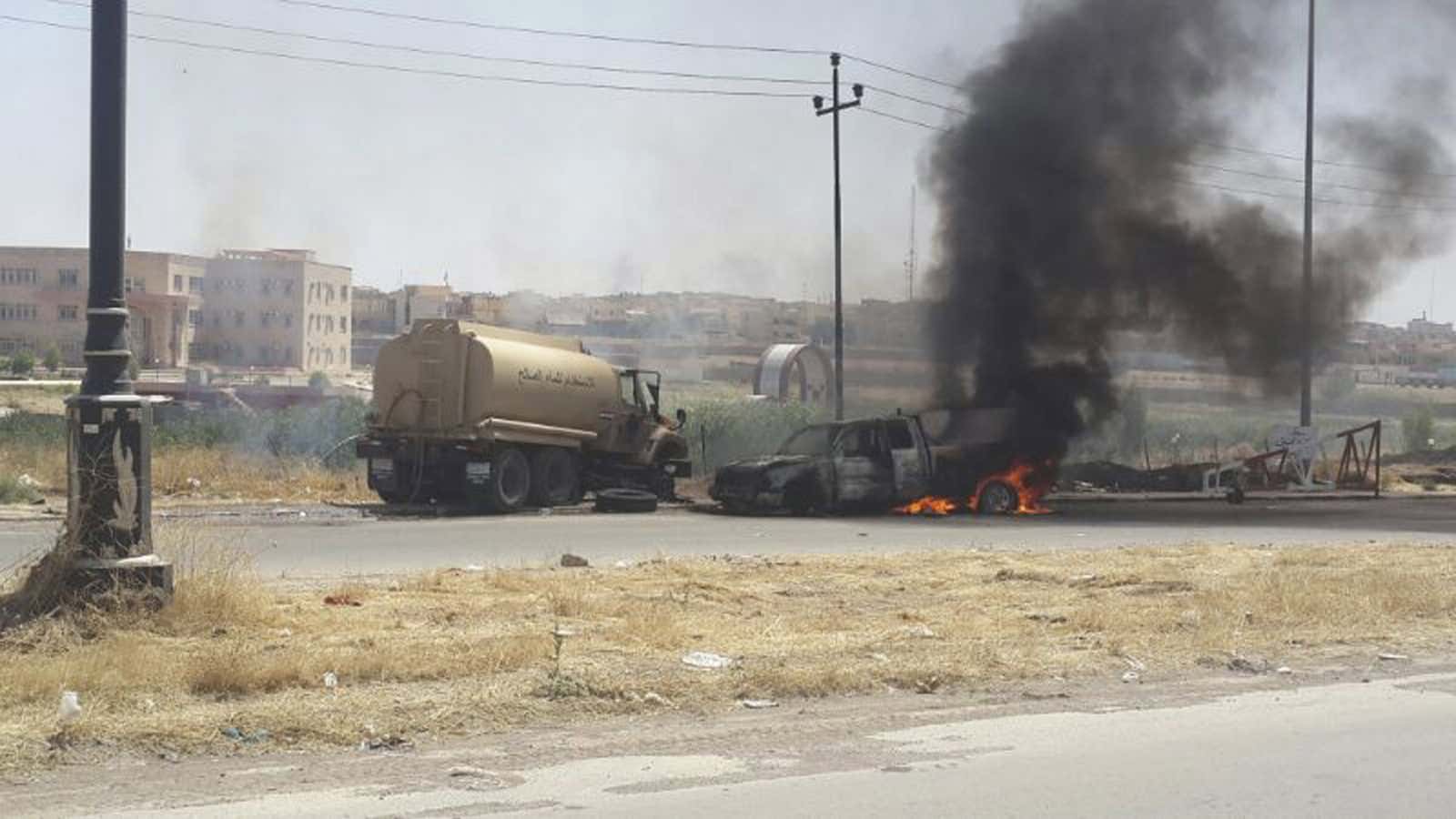 Burning vehicles belonging to Iraqi security forces in the northern city of Mosul.