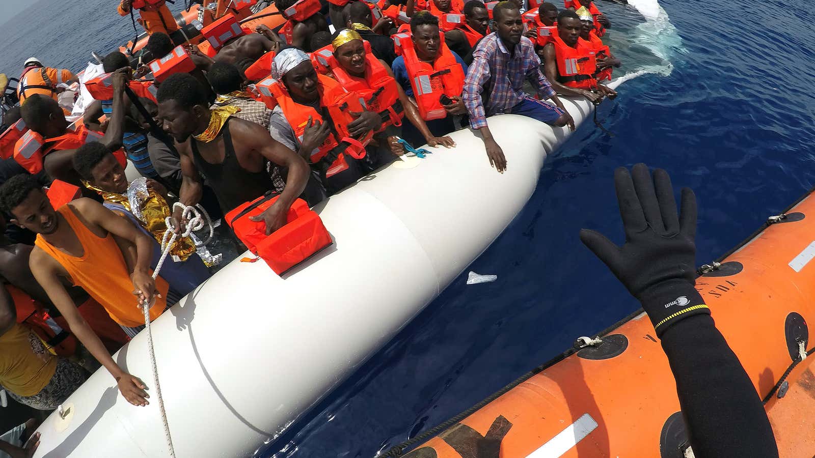 These migrants—placed on a dinghy to cross the Mediterranean sea from Libya—were rescued by a Save the Children crew in June, 2017. An estimated 2,600 have drowned making the same crossing in unseaworthy ships this year.