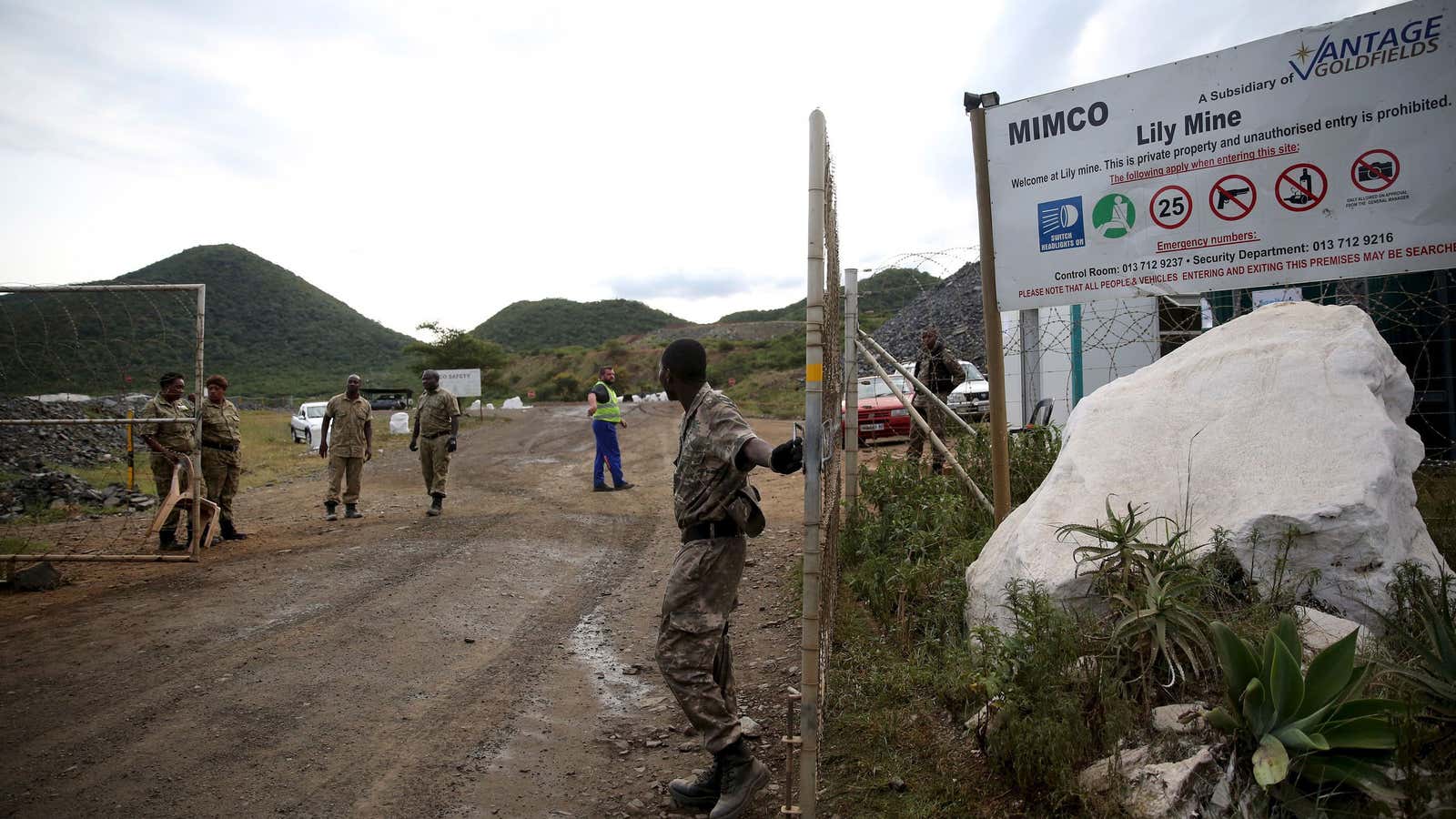 Security guards keep watch at the entrance of the Lily mine.