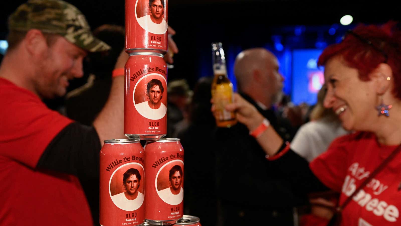 Supporters are seen with beer cans with the word Albo on it while they wait for Anthony Albanese, leader of Australia’s Labor Party, to speak about the outcome of the country’s general election.