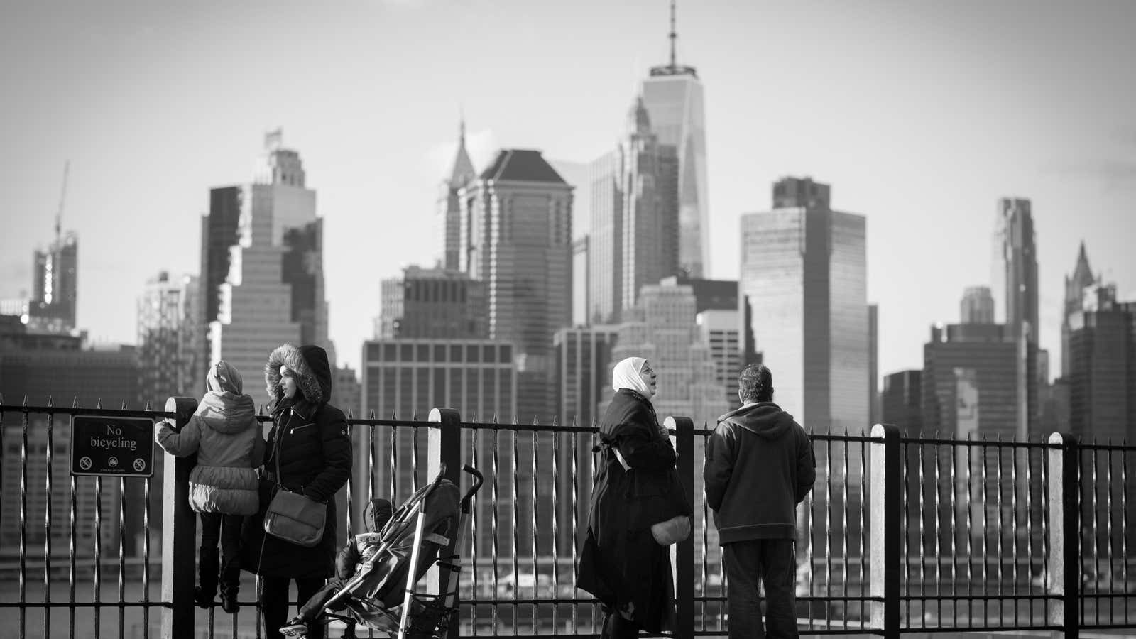 The Ferdous family take in the Manhattan skyline from the Brooklyn Heights Promenade.