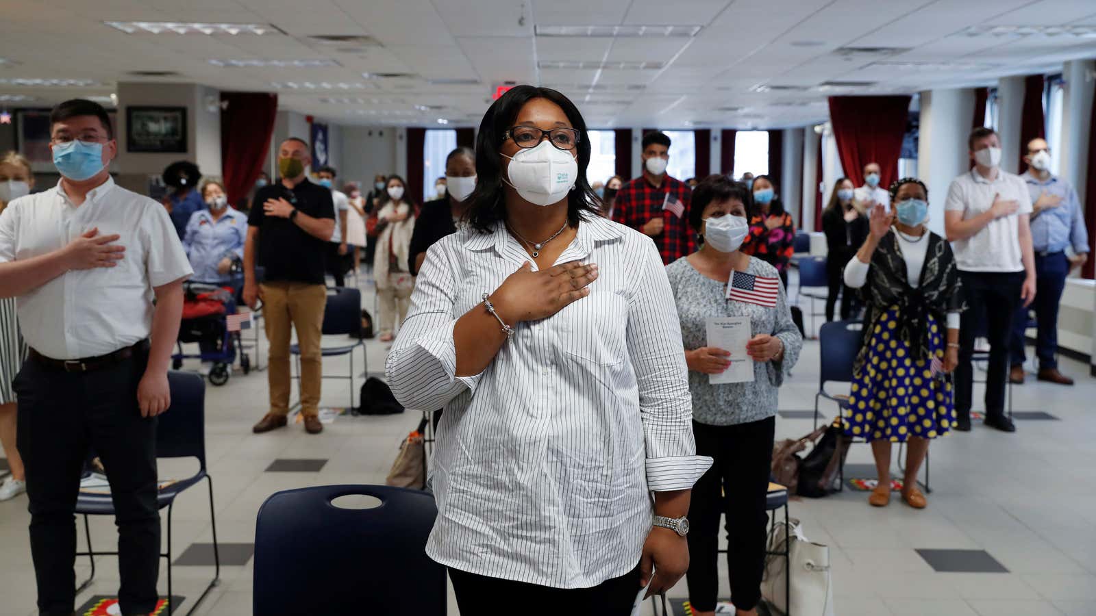 A citizen candidate from Nigeria, stands with others during a US citizenship naturalization ceremony in New York, July 22, 2020.