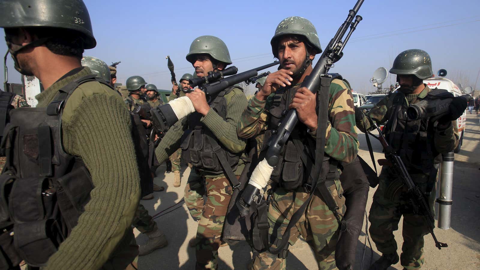 Army soldiers walk outside the Bacha Khan university in Charsadda, Pakistan, January 20, 2016.