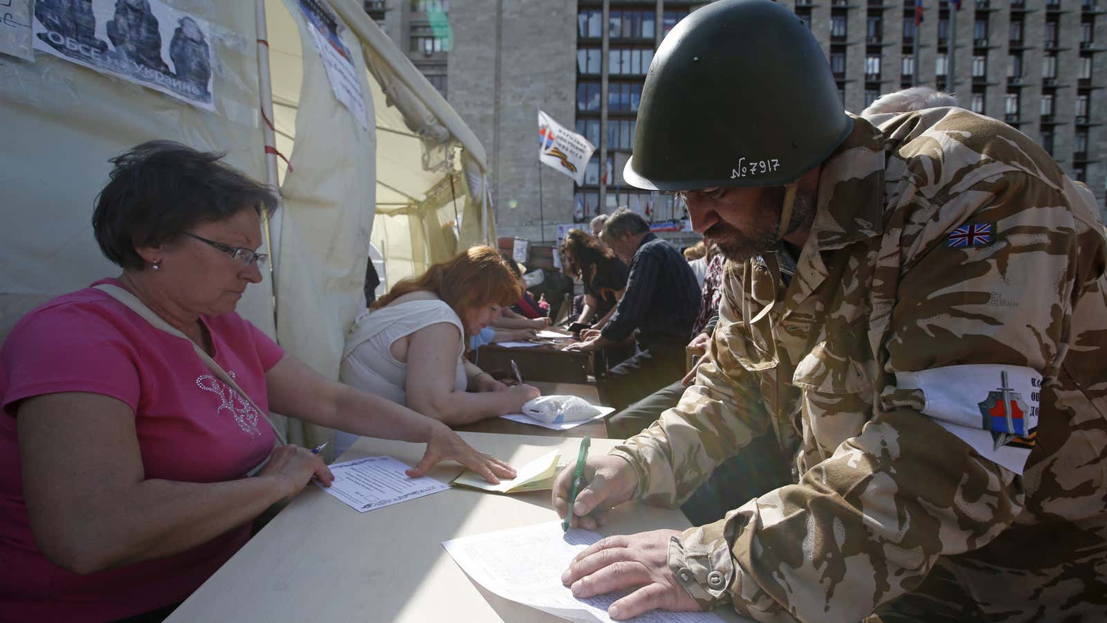 A man signs a document to receive a ballot in Donetsk on May 11.