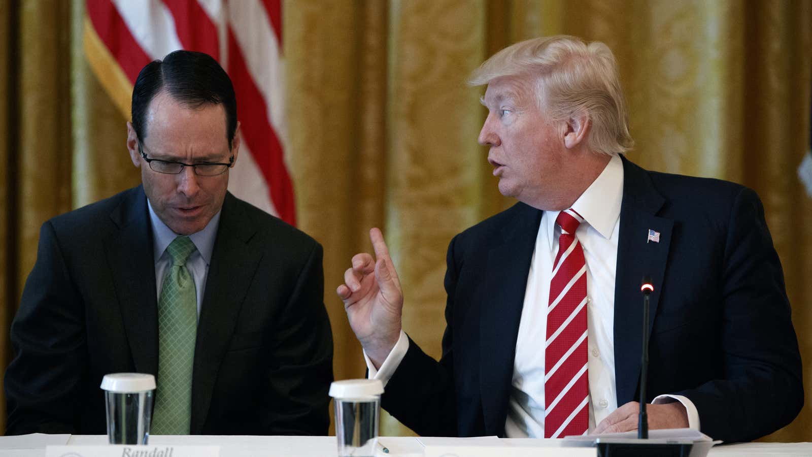 Randall Stephenson, left, listens as President Donald Trump speaks at the White House in June.