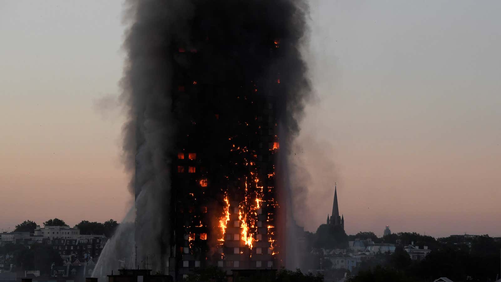 Flames and smoke billow from Grenfell Tower.