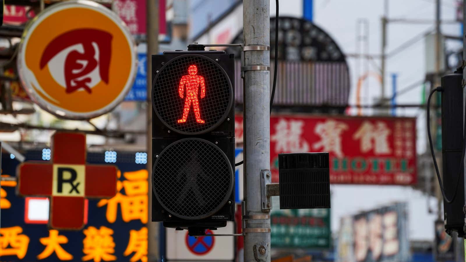 A traffic light covered with mesh wires stands in Mong Kok in Hong Kong, China, April 28, 2021. Mong Kok was a popular protest area…