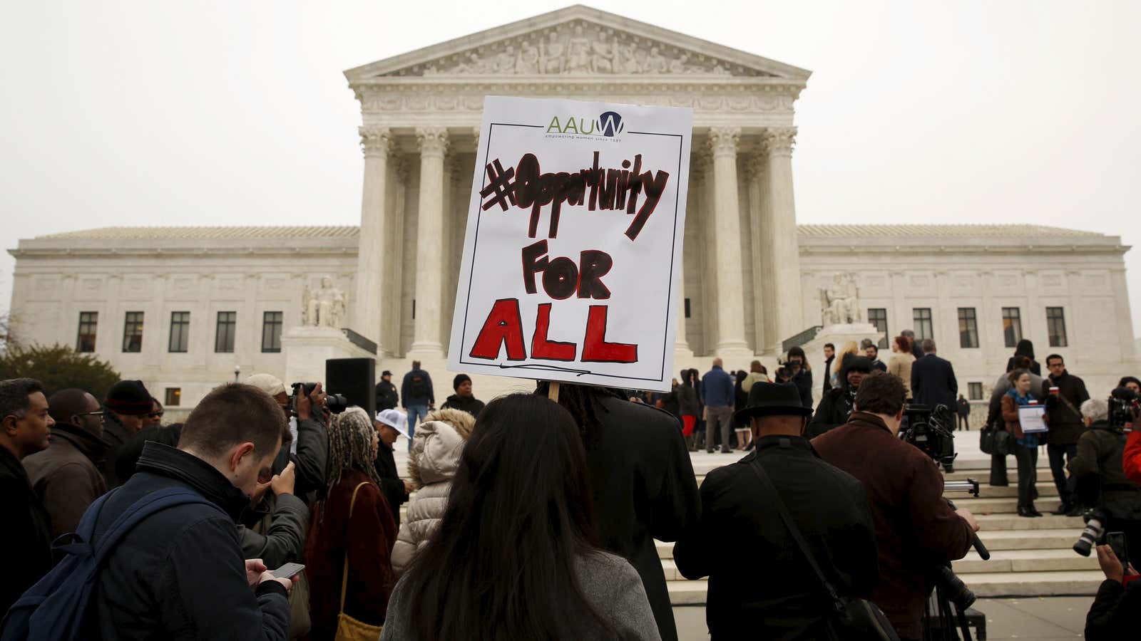 A demonstrator holds a sign aloft as the affirmative action in university admissions case was being heard at the Supreme Court in 2015. REUTERS/Kevin Lamarque