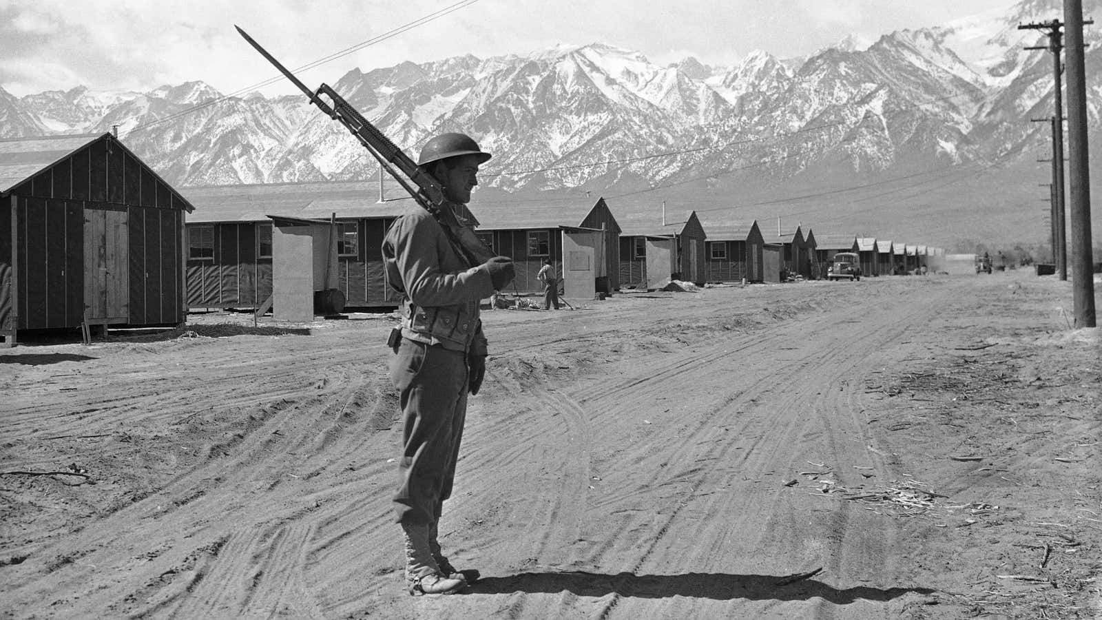 An American soldier guarding a Japanese internment camp at Manzanar, California, in 1943.