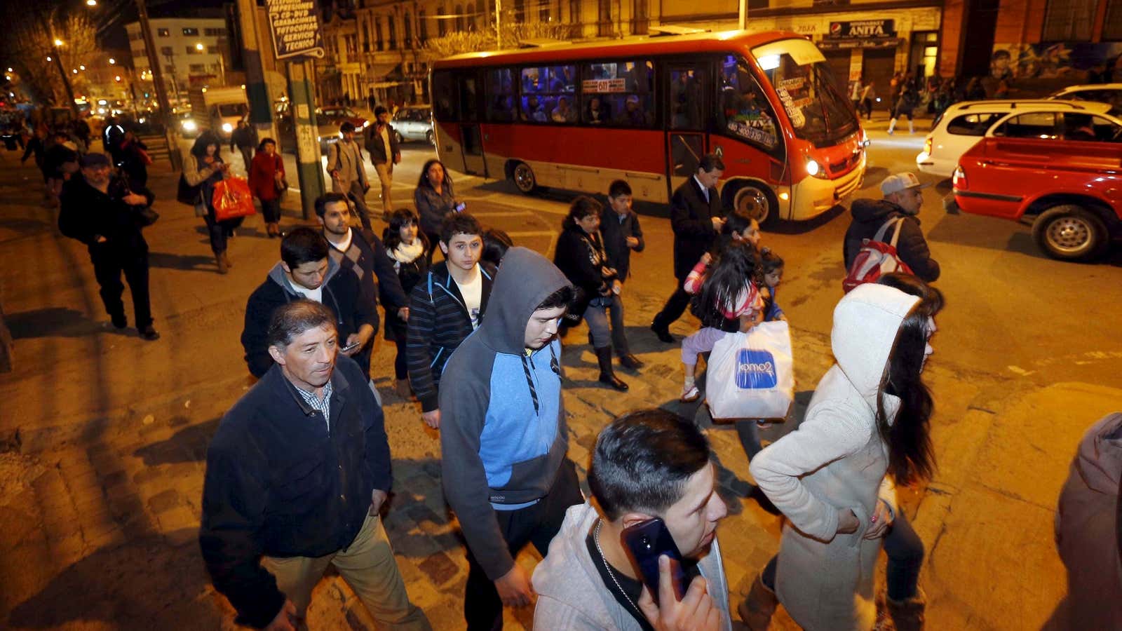 People walk to higher ground for safety, in Valparaiso City, Chile.