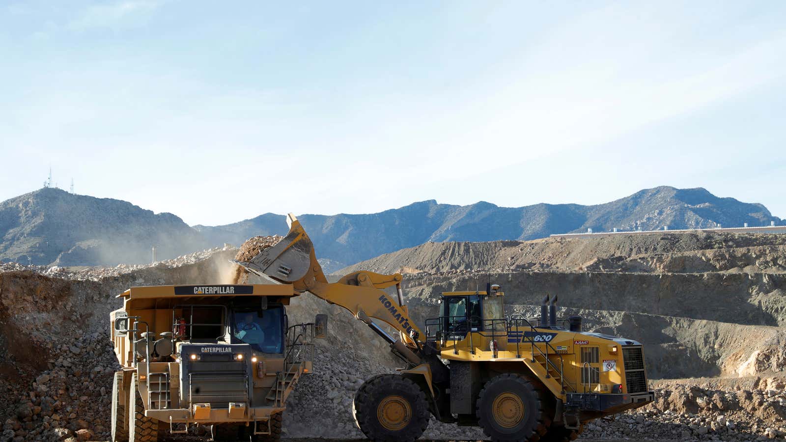 FILE PHOTO: A wheel loader operator fills a truck with ore at the MP Materials rare earth mine in Mountain Pass, California, U.S. January 30,…